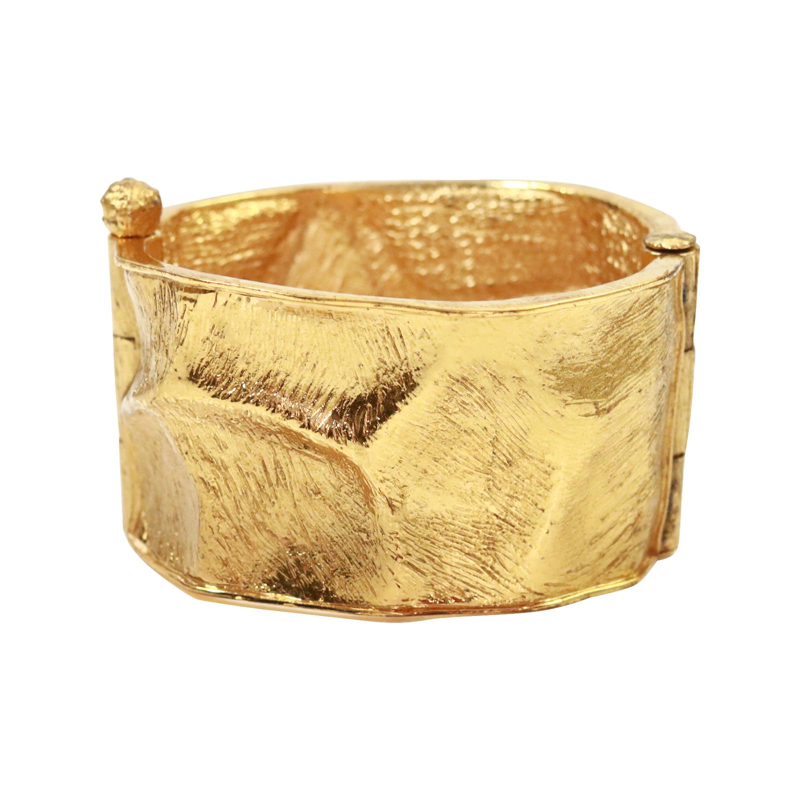 Vintage Yves Saint Laurent YSL Gold Tone Cuff Bracelet Circa 1990s. Classic cuff bracelet with indentations all around. Smaller in the front part and getting larger in the back.  Has a great looking pin closure. Heavy and substantial.   Spectacular!