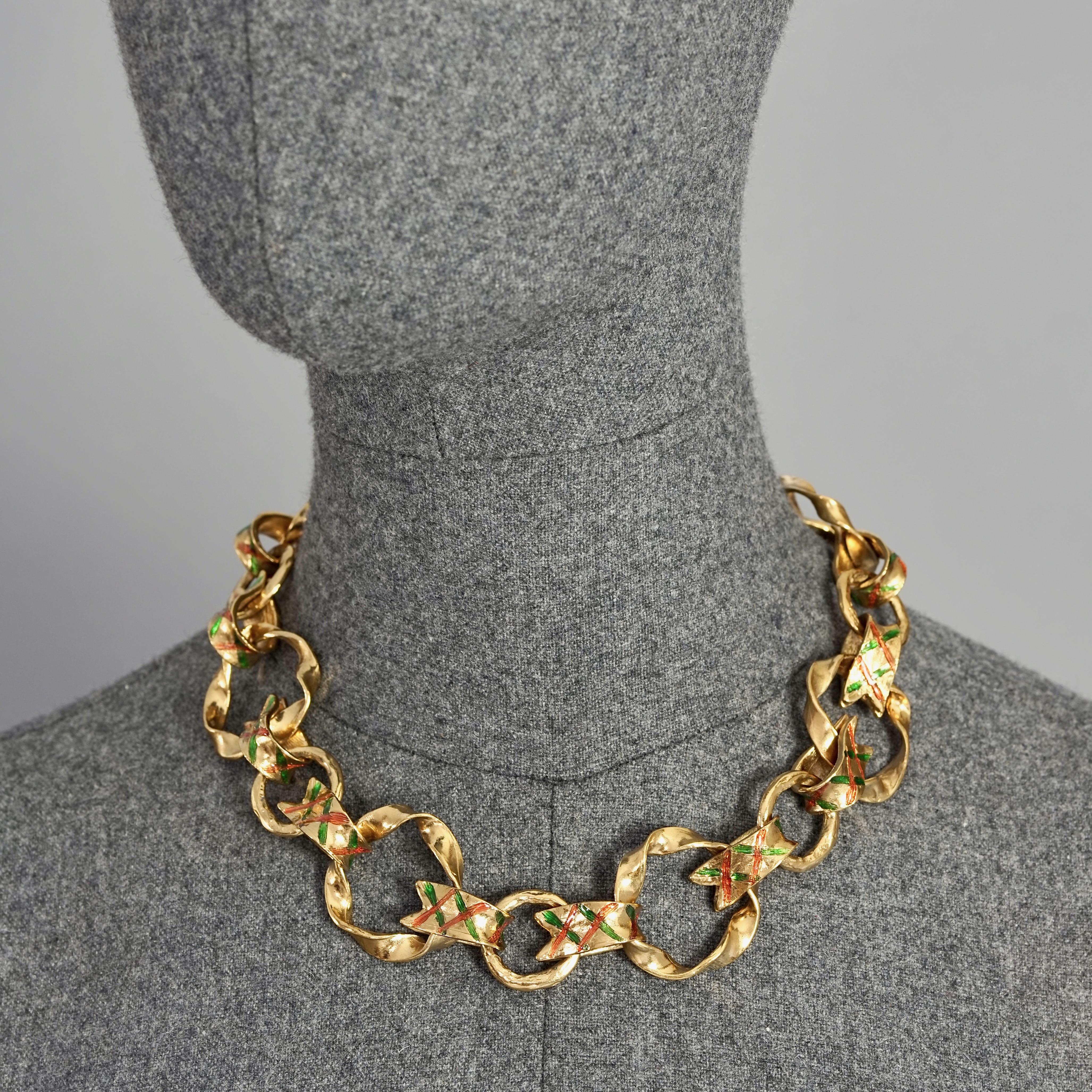 Vintage YVES SAINT LAURENT Ysl Harlequin Enamel Twisted Hoop Link Necklace

Measurements:
Height: 1.30 inches (3.3 cm)
Wearable Length : 17.51 inches to 19.29 inches (44.5 cm to 49 cm)

Features:
- 100% Authentic YVES SAINT LAURENT.
- Twisted hoop