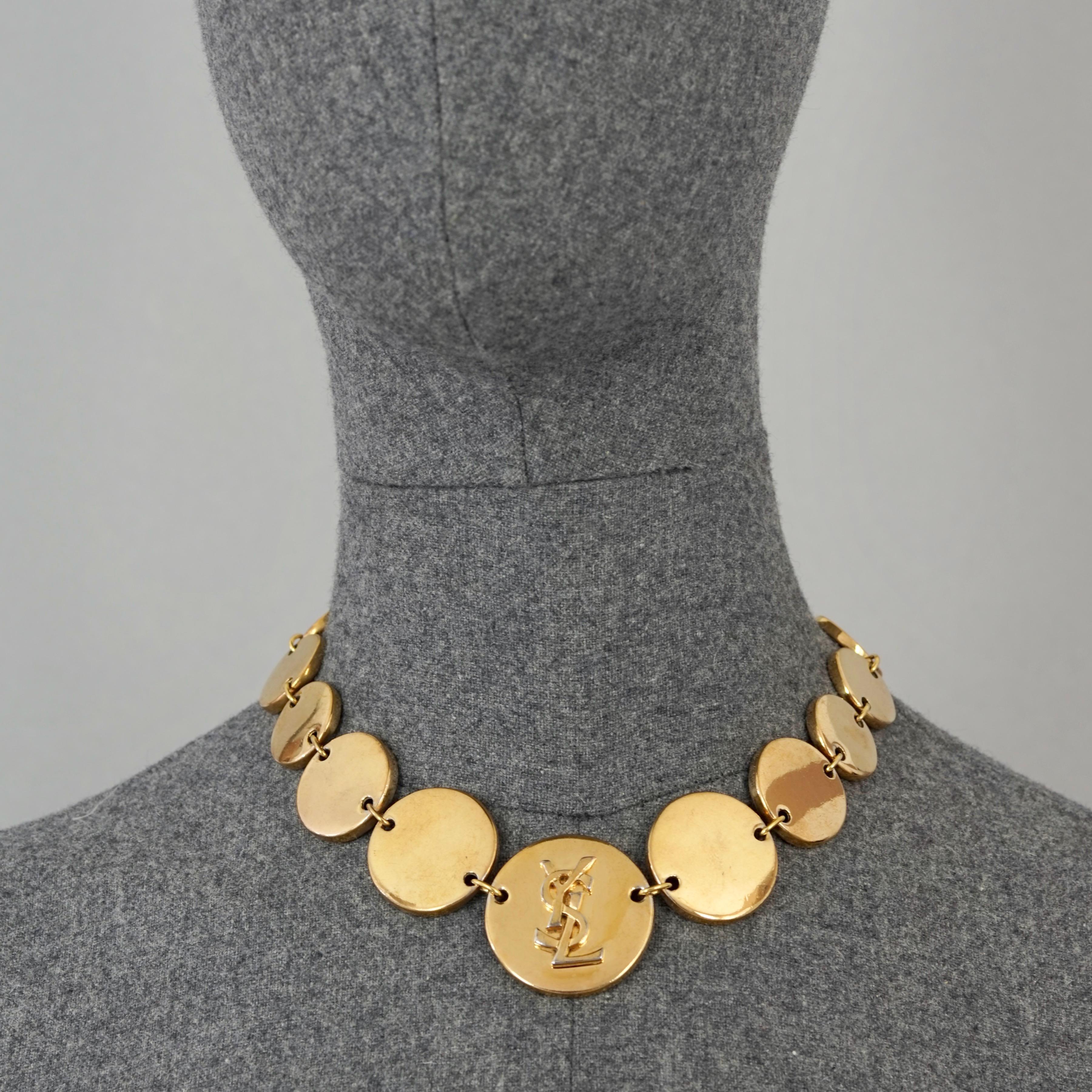 Vintage YVES SAINT LAURENT Ysl Logo Medalion Link Necklace

Measurements:
Height: 1.42 inches (3.6 cm)
Width: 16.53 inches (42 cm) to 18.50 inches (47 cm)

Features:
- 100% Authentic YVES SAINT LAURENT.
- Disc medallion link necklace with embossed
