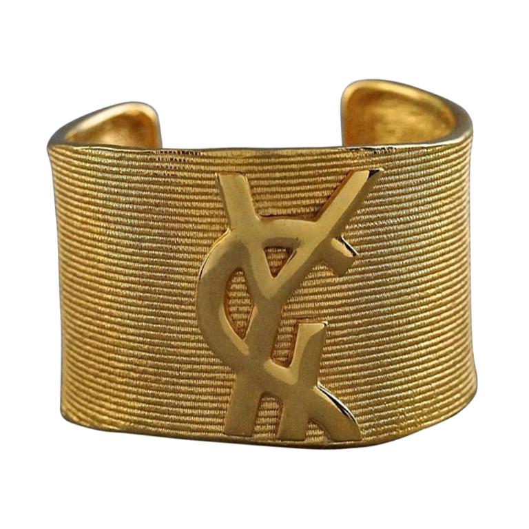 Vintage YVES SAINT LAURENT Ysl Logo Ribbed Gold Cuff Bracelet For Sale at  1stDibs | ysl cuff bracelet, saint laurent cuff bracelet, ysl bracelet