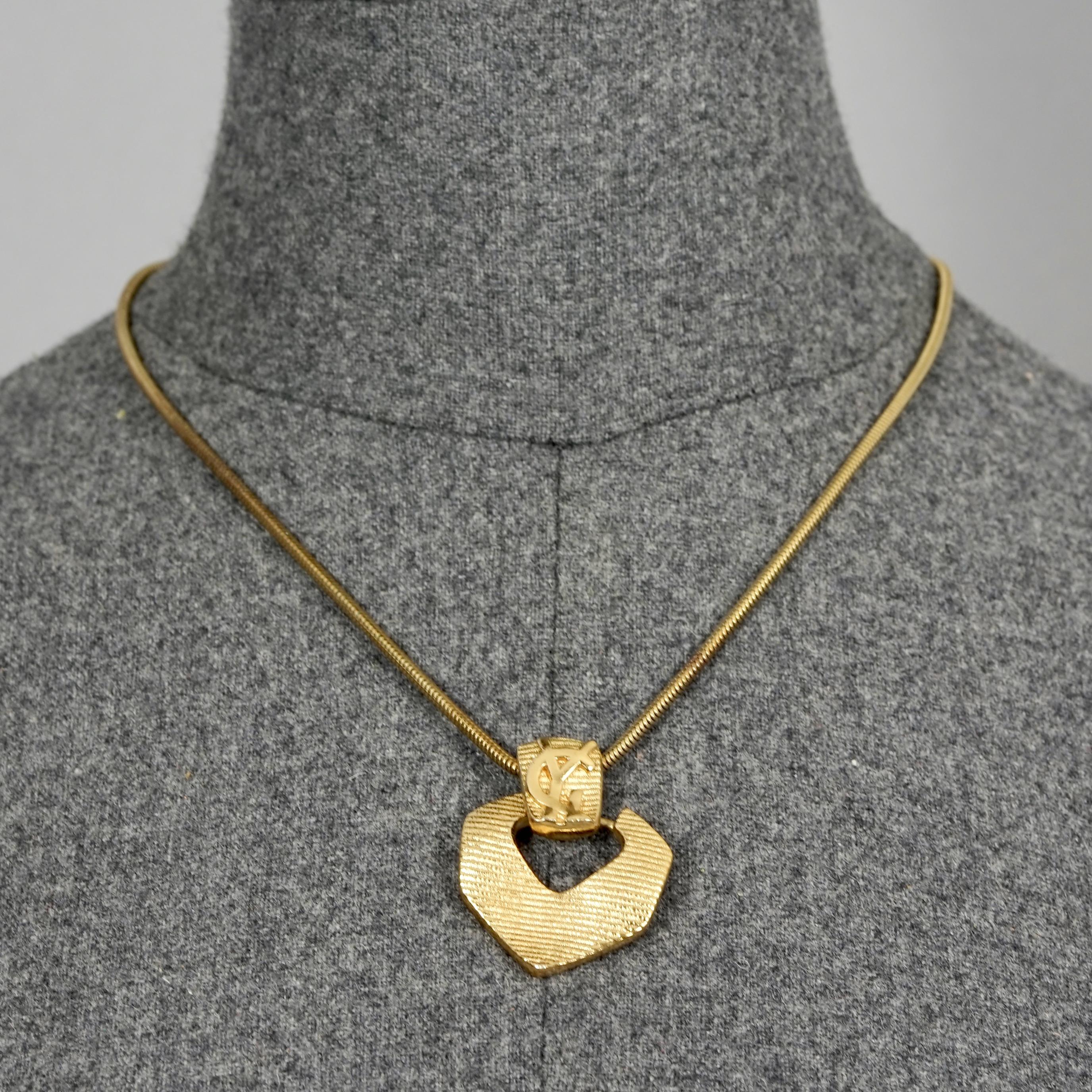 Vintage YVES SAINT LAURENT Ysl Logo Ribbed Pendant Snake Chain Necklace

Measurements:
Height: 1.50 inches (3.8 cm)
Wearable Length: 17.51 inches (44.5 cm) until 19.48 inches (49.5 cm)

Features:
- 100% Authentic YVES SAINT LAURENT.
- Ribbed pendant