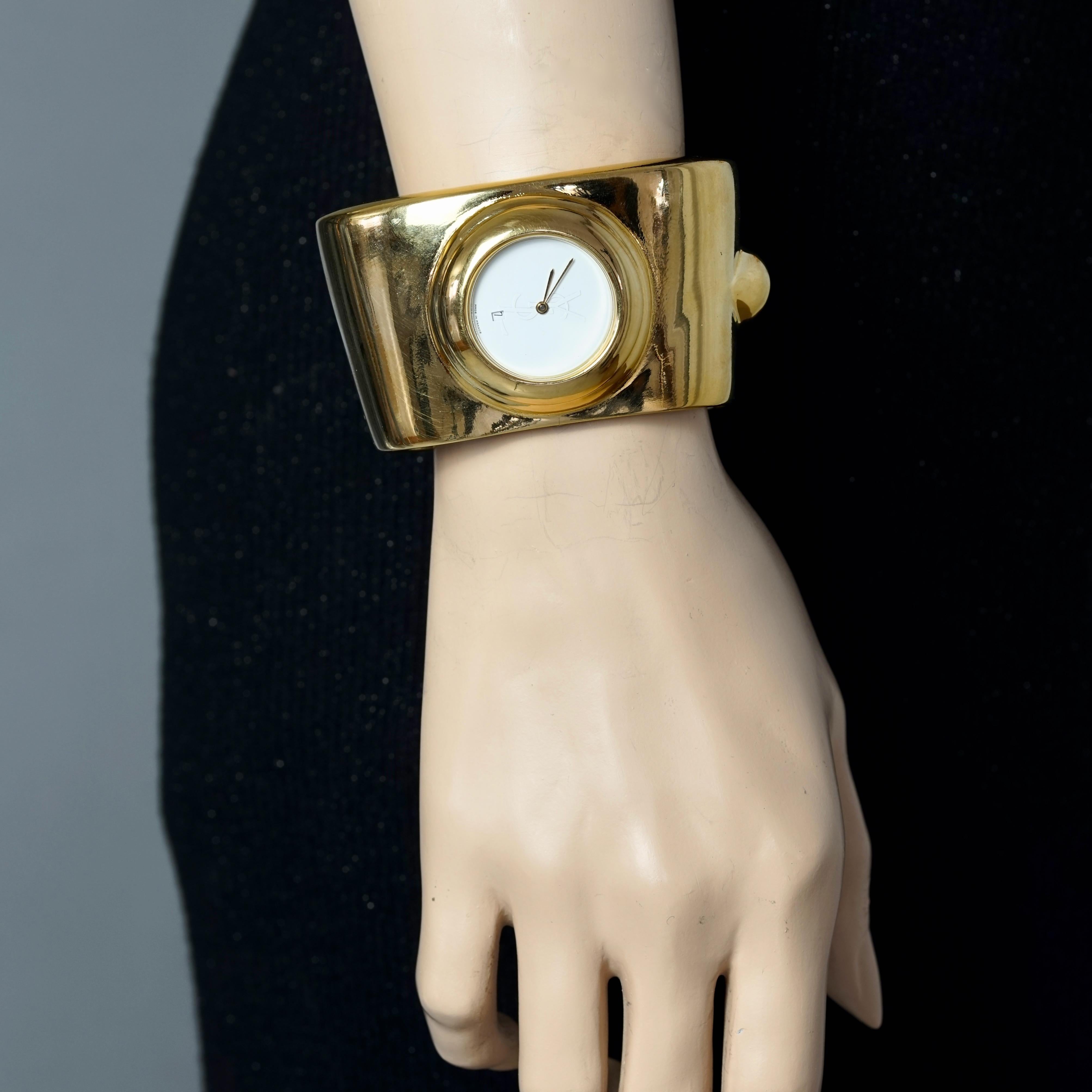 Vintage YVES SAINT LAURENT Ysl Logo Space Age Watch Clamper Cuff Bracelet 

Measurements:
Height: 1.73 inches (4.4 cm)
Overall Circumference: 5.98 inches (15.2 cm)
Horizontal Diameter: 3.03 inches (7.7 cm)
Vertical Diameter: 2.40 inches (6.1