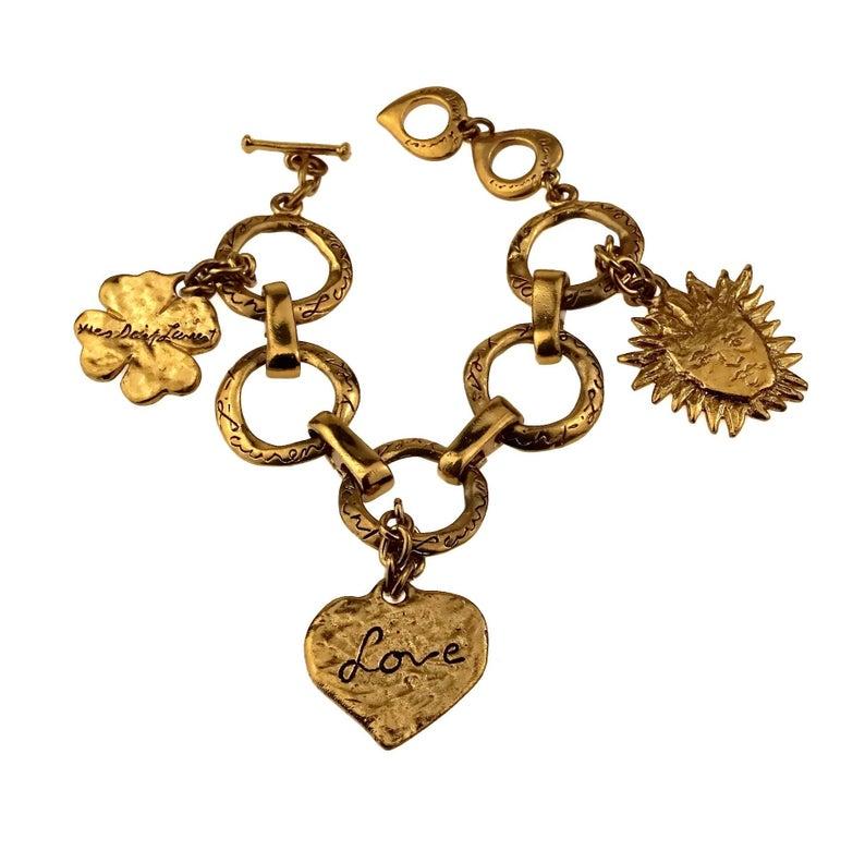 Vintage YVES SAINT LAURENT Ysl Love by Robert Goossens Sun Clover Heart Charm Bracelet

Measurements:
Height: 2.40 inches (6.1 cm)
Wearable Length: 7.48 inches to 8.26 inches (19 cm to 21 cm)

Features:
- 100% Authentic YVES SAINT LAURENT by Robert