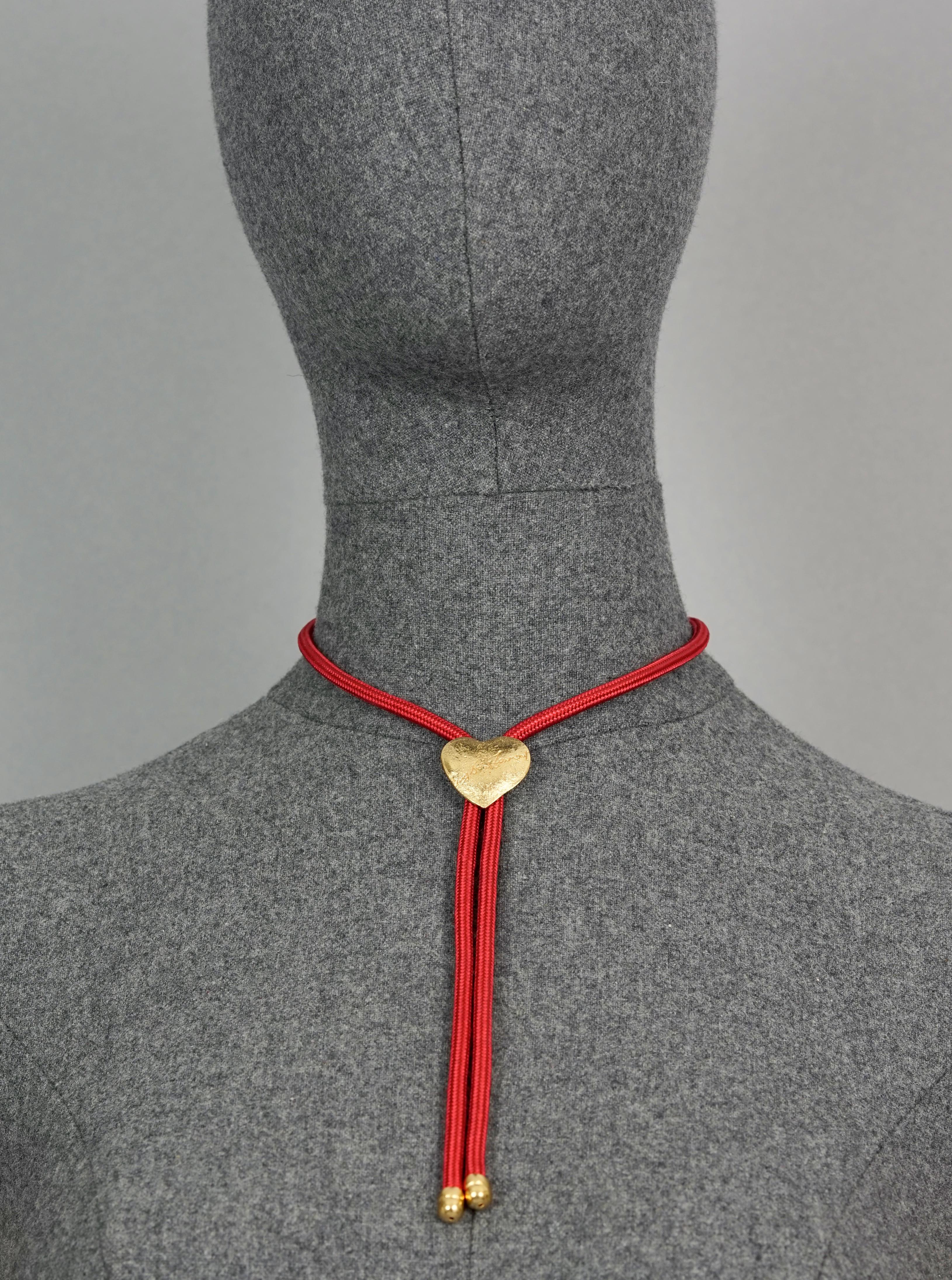 Vintage YVES SAINT LAURENT Ysl Love Heart Red Lariat Rope Necklace

Measurements:
Height Heart: 0.90 inch (2.3 cm)
Width Heart: 0.98 inch (2.5 cm)
Cord: 24.80 inches (63 cm)

Features:
- 100% Authentic YVES SAINT LAURENT.
- Heart pendant necklace