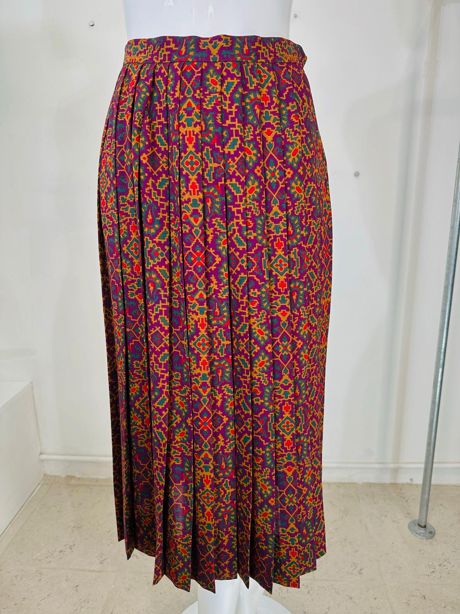 Vintage Yves Saint Laurent Rive Gauche  moorish print challis knife pleated skirt from the 1970s. Rich colour printed, fine wool fabric, in shades of purple, green, red and amber. Sharp open pleated skirt has a banded waist with a side painted metal