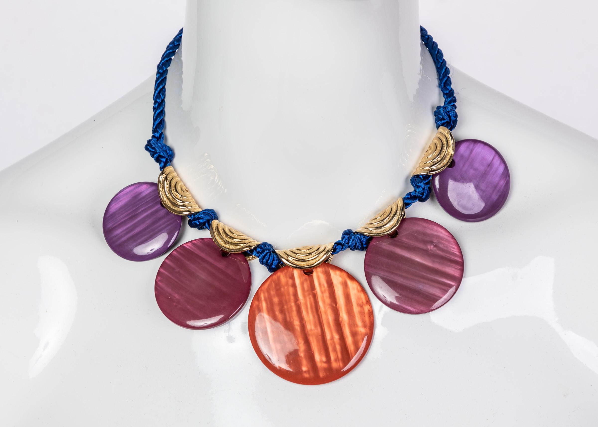 With any outfit, the accessories are half the battle. For all of his collections, YSL was sure to create accessories to elevate his ensembles for maximum impact. This necklace is designed from cool toned analogous colors. Five round pendants in