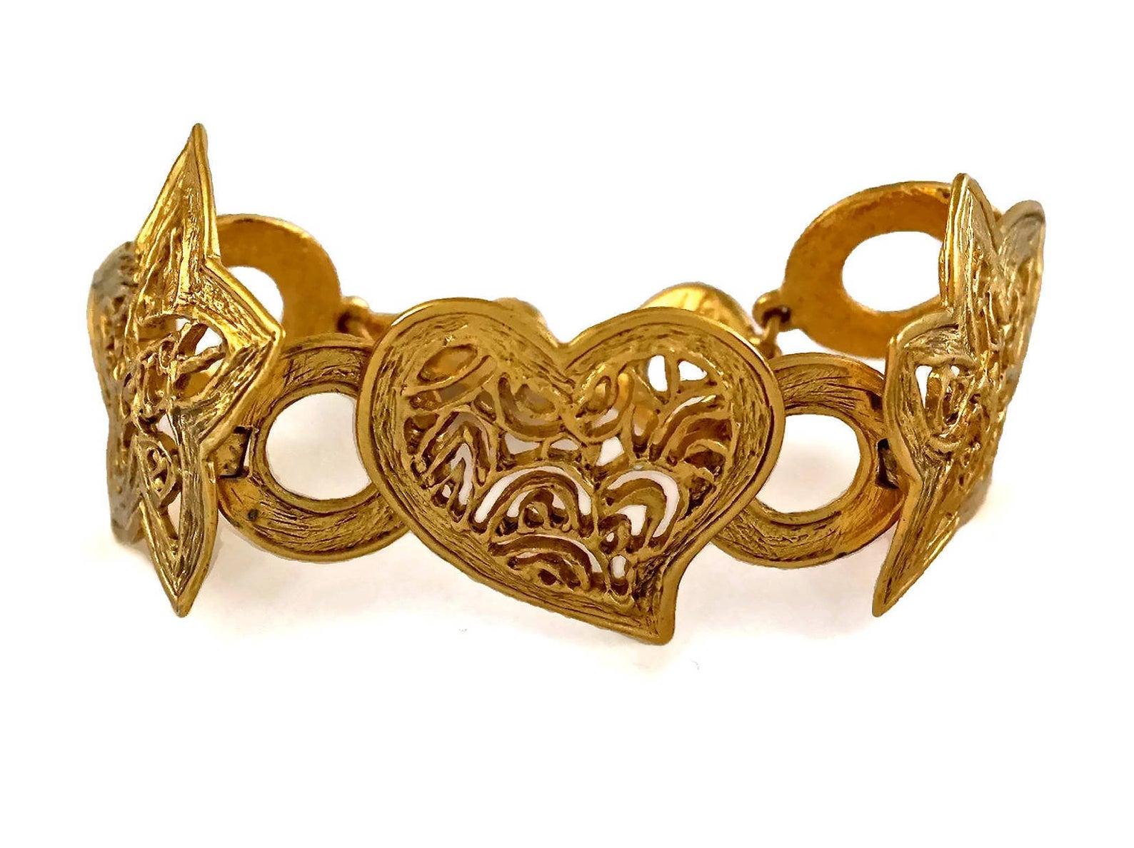 Vintage YVES SAINT LAURENT Ysl Openwork Heart Star Bracelet

Measurements:
Height: 1.65 inches (4.2 cm)
Length: 7.28 inches to 8.46 inches (18.5 cm to 21.5 cm)

Features:
- 100% authentic YVES SAINT LAURENT.
- Heart and stars link with openwork