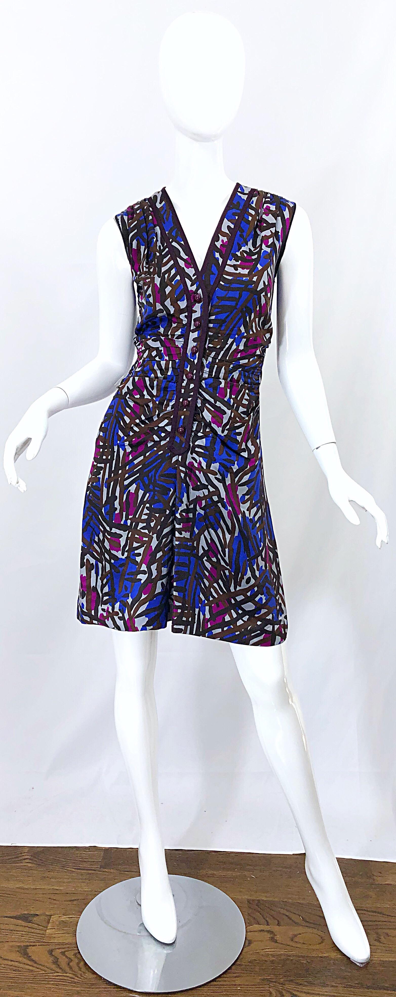 Spectacular vintage YVES SAINT LAURENT Rive Gauche YSL tribal graffiti print silk dress! Features vibrant colors of purple, fuchsia pink, brown and burgundy throughout. Buttons up the front with hook-and-eye closure above the top button. Flattering