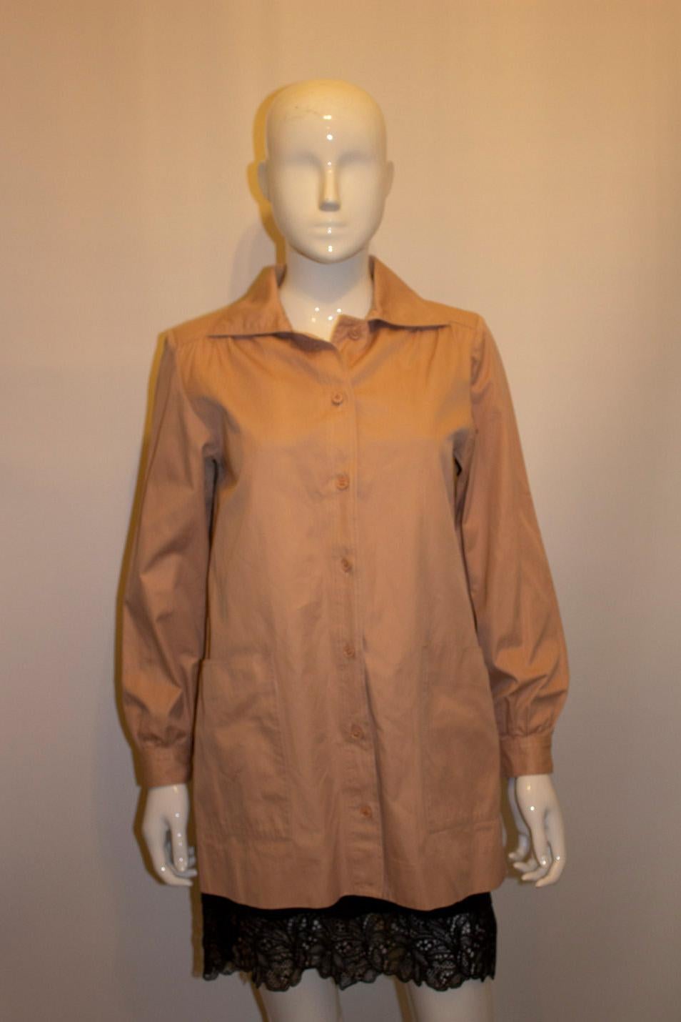 A pretty and useful , vintage pink cotton shacket  ( shirt/ jacket) , by Yves Saint Laurent Rive Gauche. In a heavy cotton, the shirt has gathering on the shoulders, large pockets on the front and single button cuffs. Made in France , measurements;