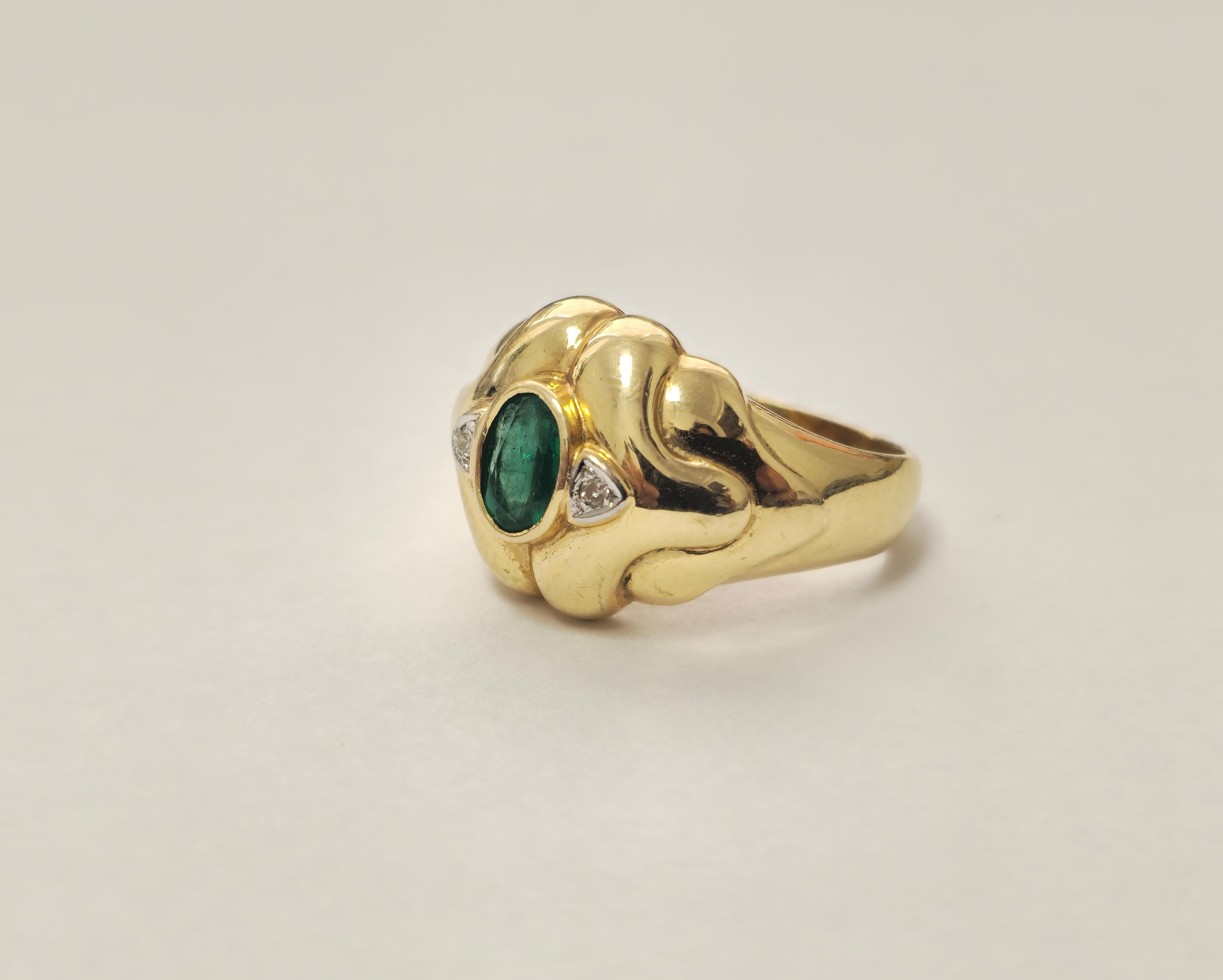 Experience timeless elegance with this vintage art deco style engagement ring. Crafted in luxurious 18k yellow gold, it showcases a stunning 1.50 carat round emerald in delicate prong setting, highlighting its natural earth-mined beauty. Surrounding
