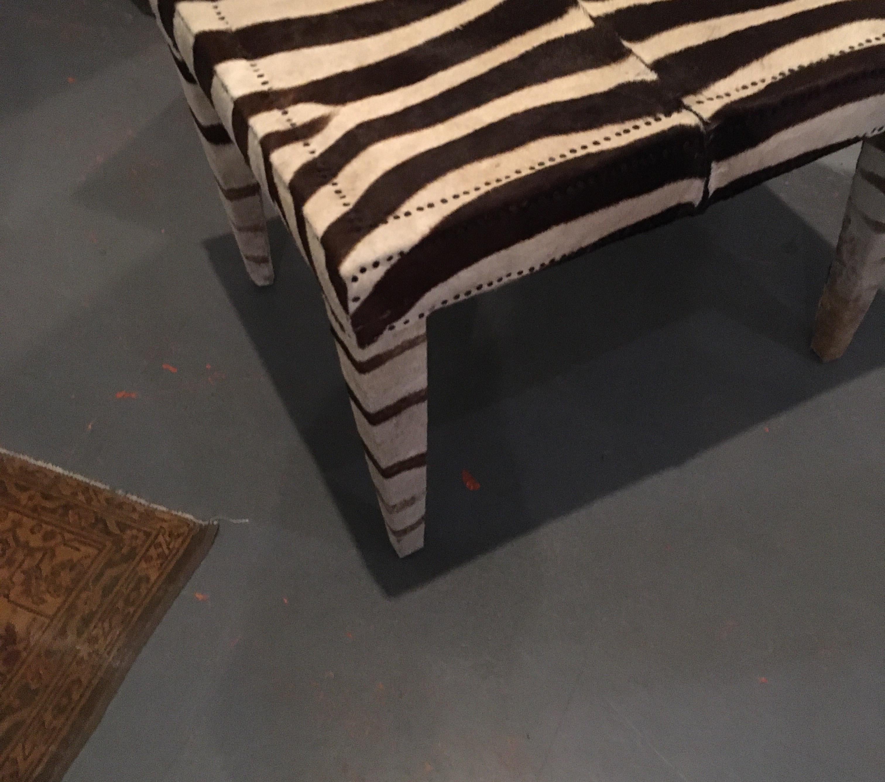 Very sturdy bench or side table custom made and upholstered in vintage zebra trimmed with nailheads. Also works well for extra seating at dining table.