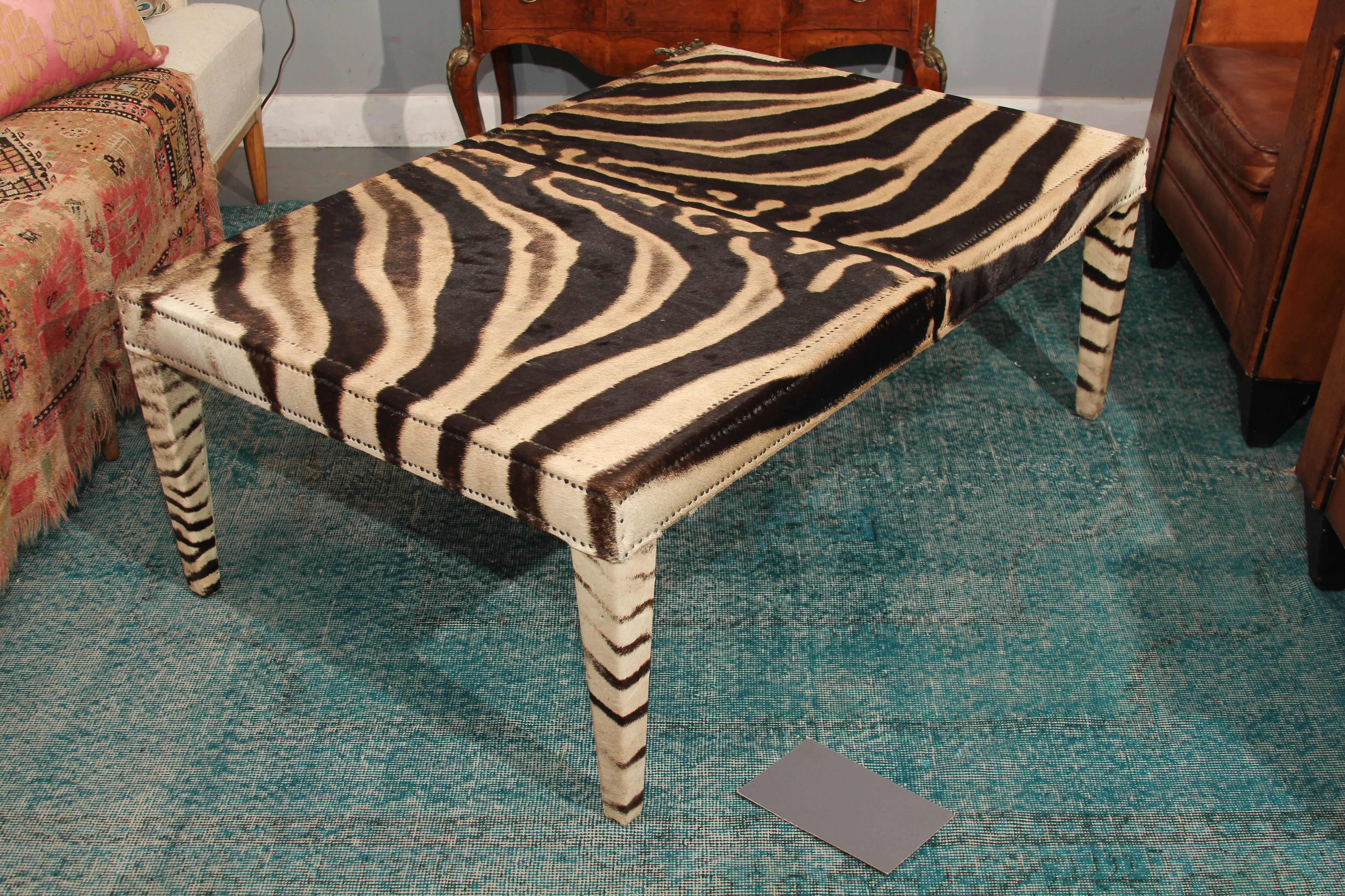 Very handsome coffee table in vintage zebra hide, trimmed in small nailheads.