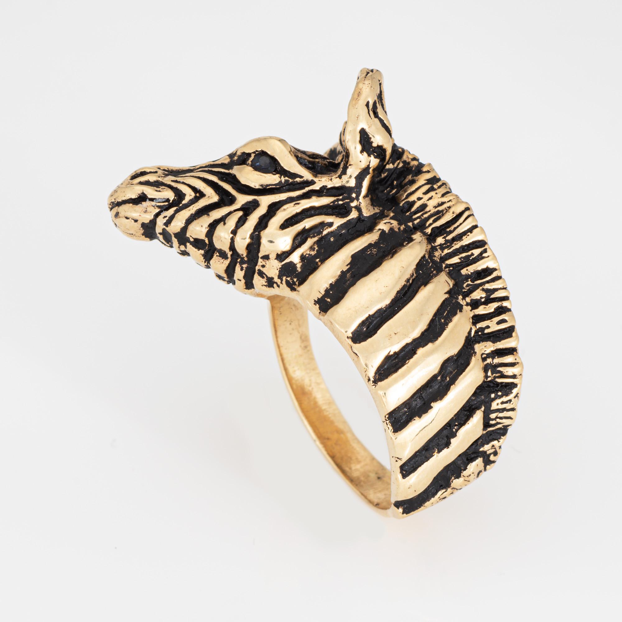 Distinct & stylish vintage zebra ring (circa 1960s to 1970s) crafted in 14 karat yellow gold. 

Two small black stones are set into the eyes. 

The sweet ring highlights a beautifully detailed zebra with stripes rendered in black enamel. The ring