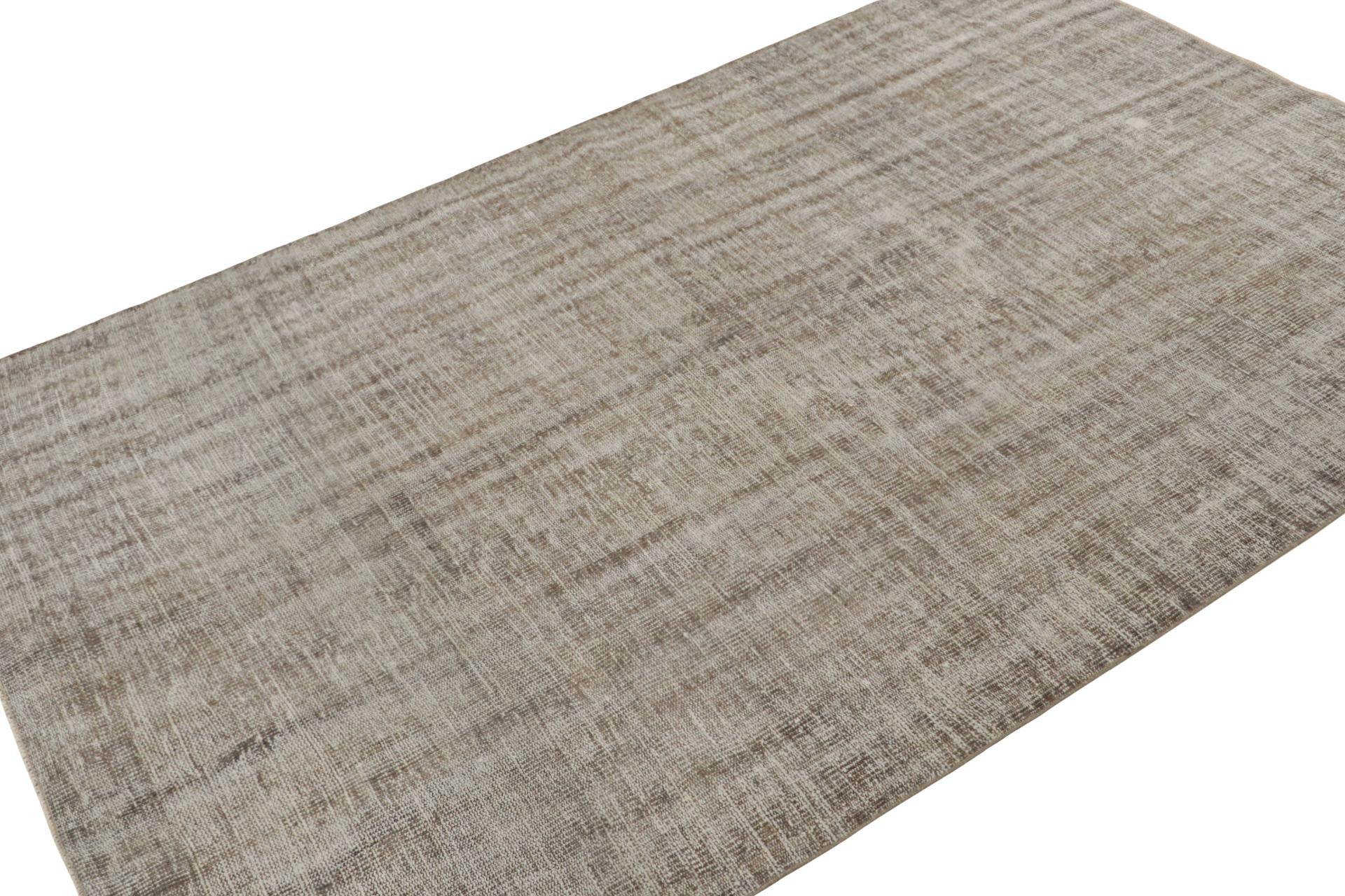 This vintage 6x9 rug, hand-knotted in wool, circa 1960-1970,  is a subdued piece, almost plain if it weren’t for the textural accent and the tone-on-tone element of striae it lends this play of beige-brown and gray hues  

On the Design:
