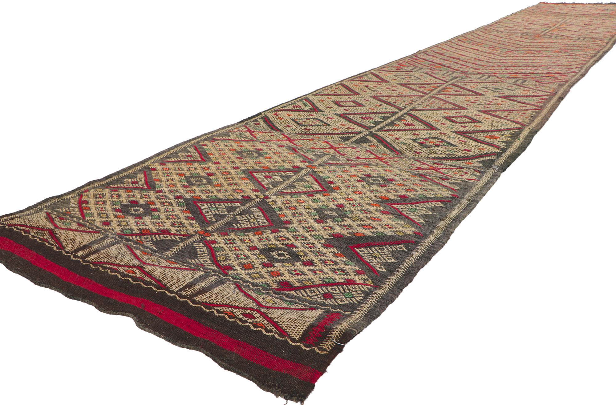 21709 Vintage Zemmour Moroccan Kilim runner, 03'00 x 17'03. Full of tiny details and tribal style, this hand-woven wool vintage Zemmour Berber Moroccan kilim rug runner is a captivating vision of woven beauty. The abrashed field is composed of