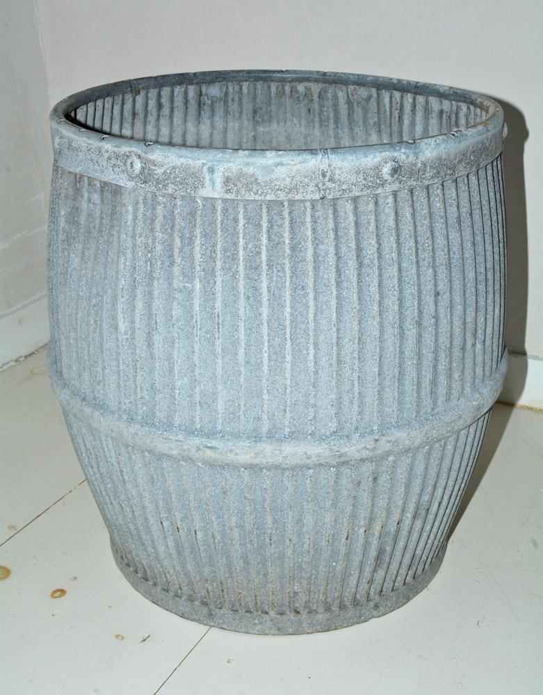 Charming zinc barrel with painted decoration was once used in early 20th century, England as a laundry alternative to the washboard, these antique, galvanized zinc with aged patina can be used for storage, spacious planters, vessels for firewood, or
