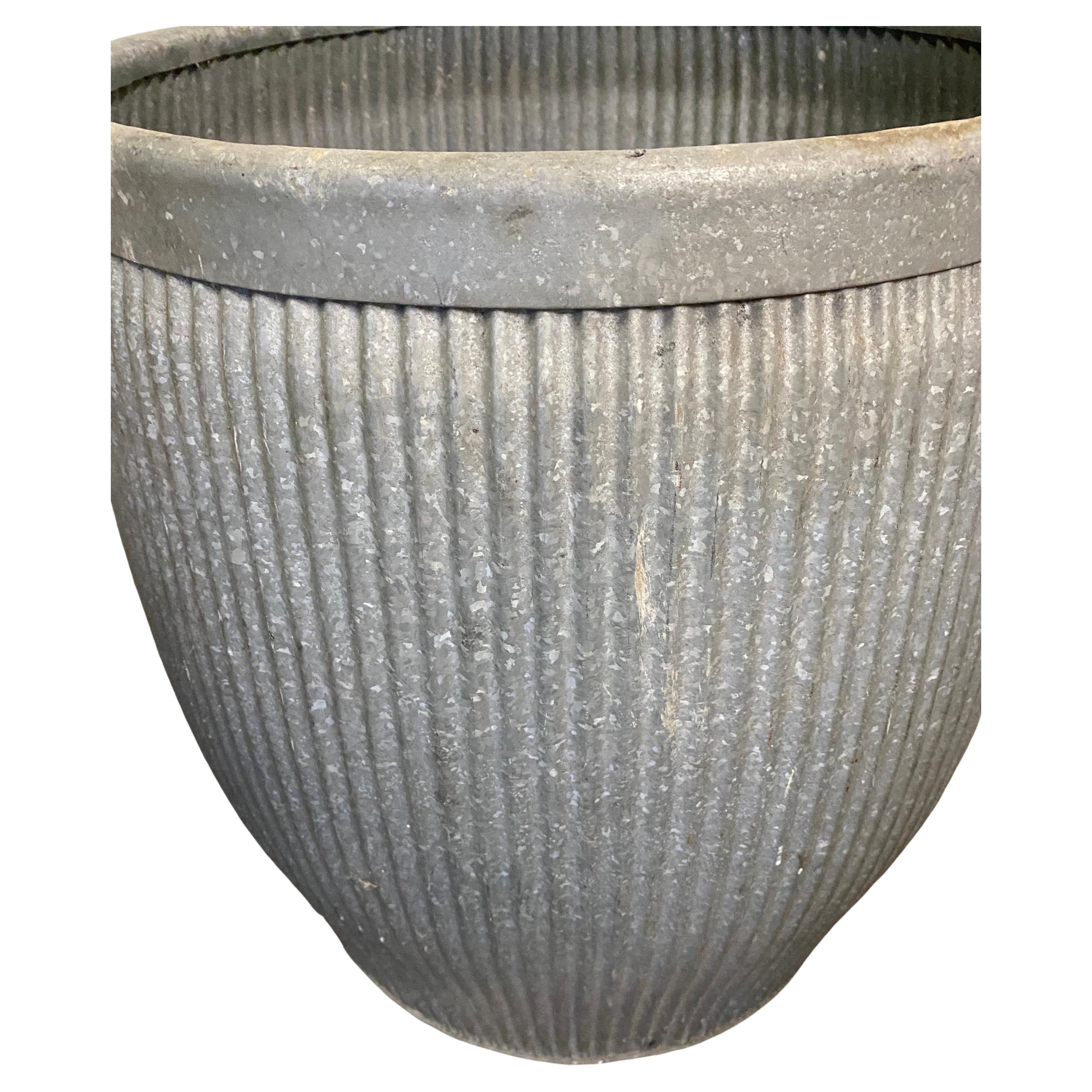 Charming zinc barrel was once used in early 20th century England as a laundry alternative to the washboard, these antique, galvanized barrel with aged patina can be used for storage, planters, vessels for firewood, or easy organizers in the home.