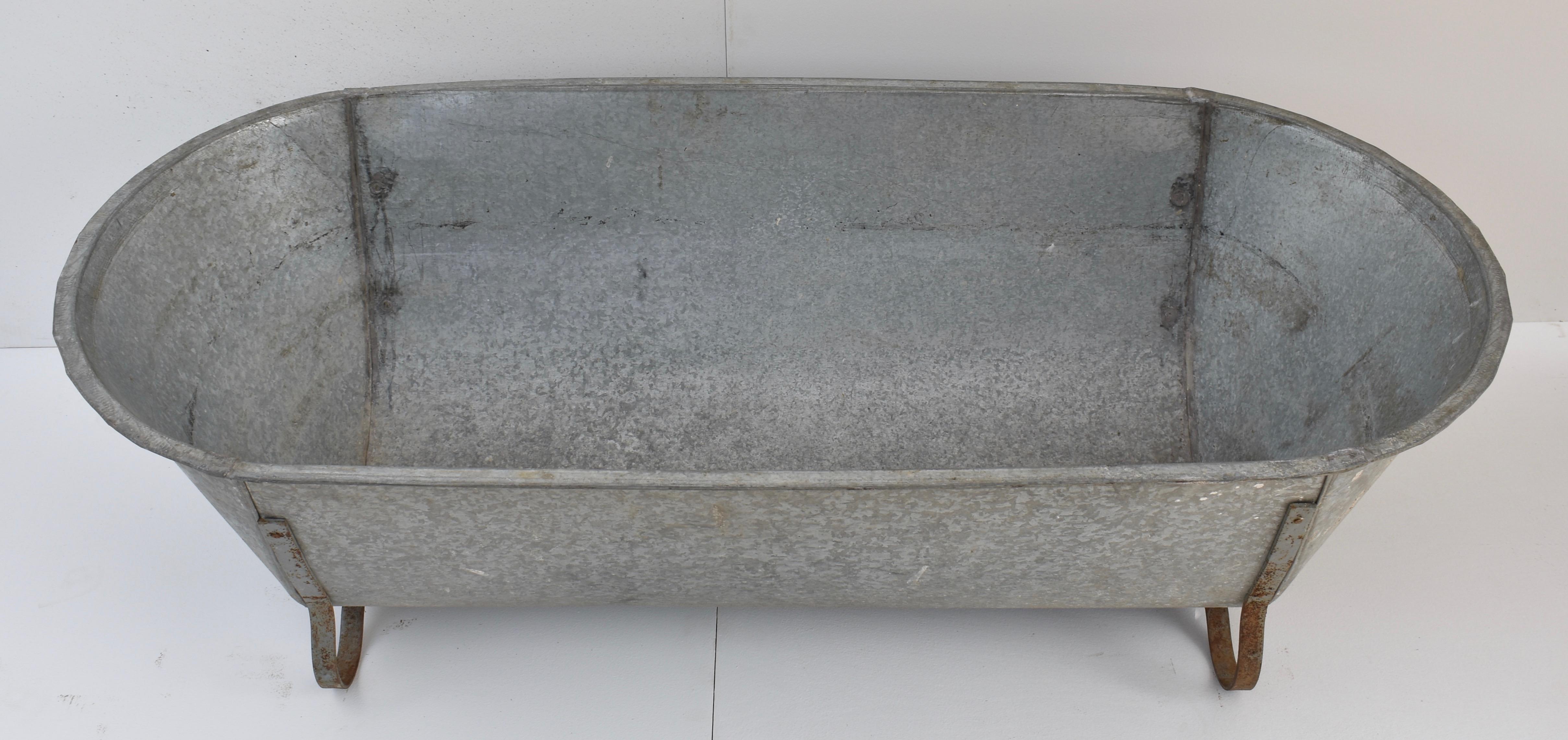 This is a Central European zinc bathtub with attractive curled iron feet.