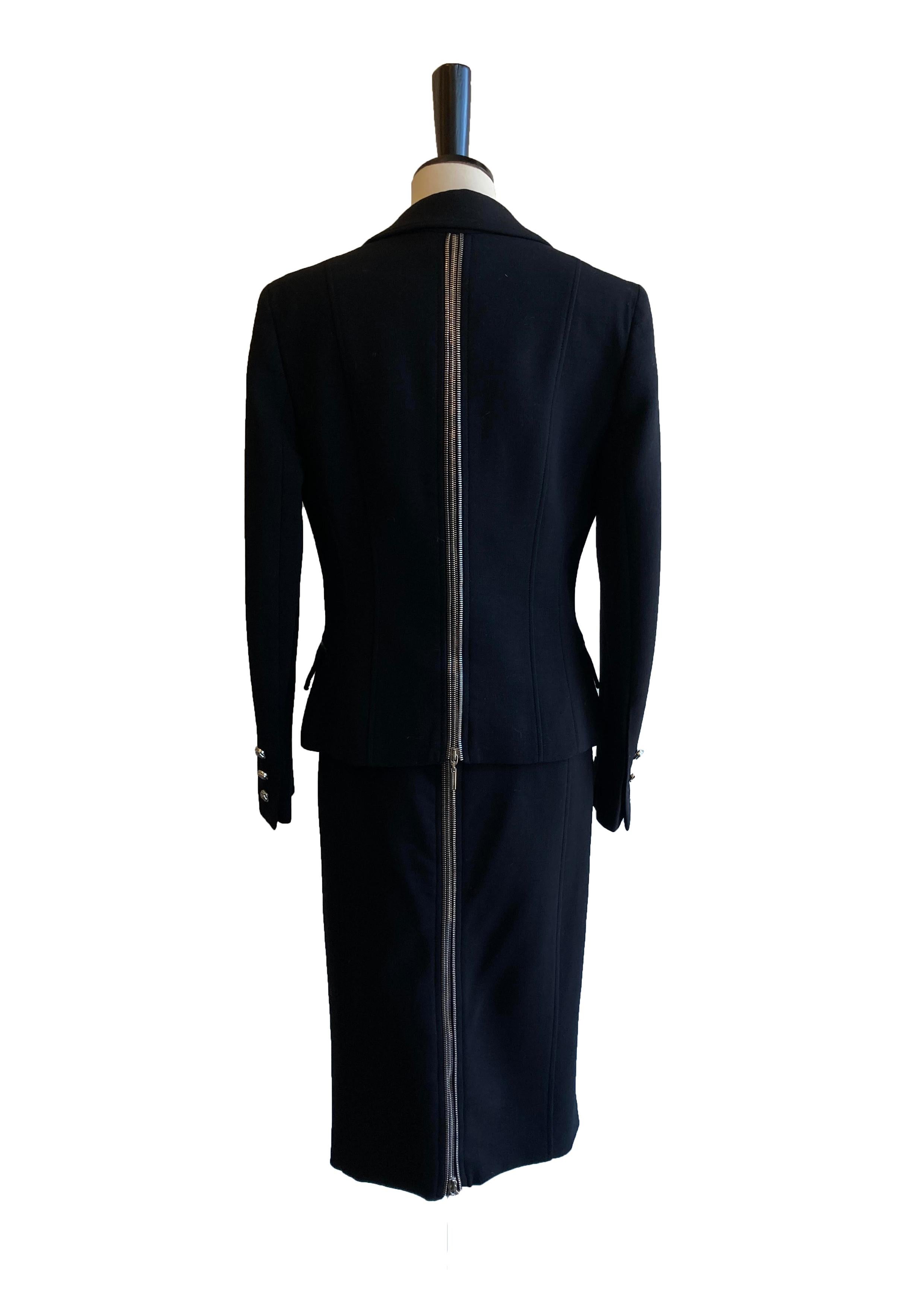 Vintage Gianni Versace skirt suit. Embellished with statement zip detail running all the way up the back. Jacket has lapels, paneling and flap over pockets with decorative zip detail. Single breasted and fastened with two silver toned buttons