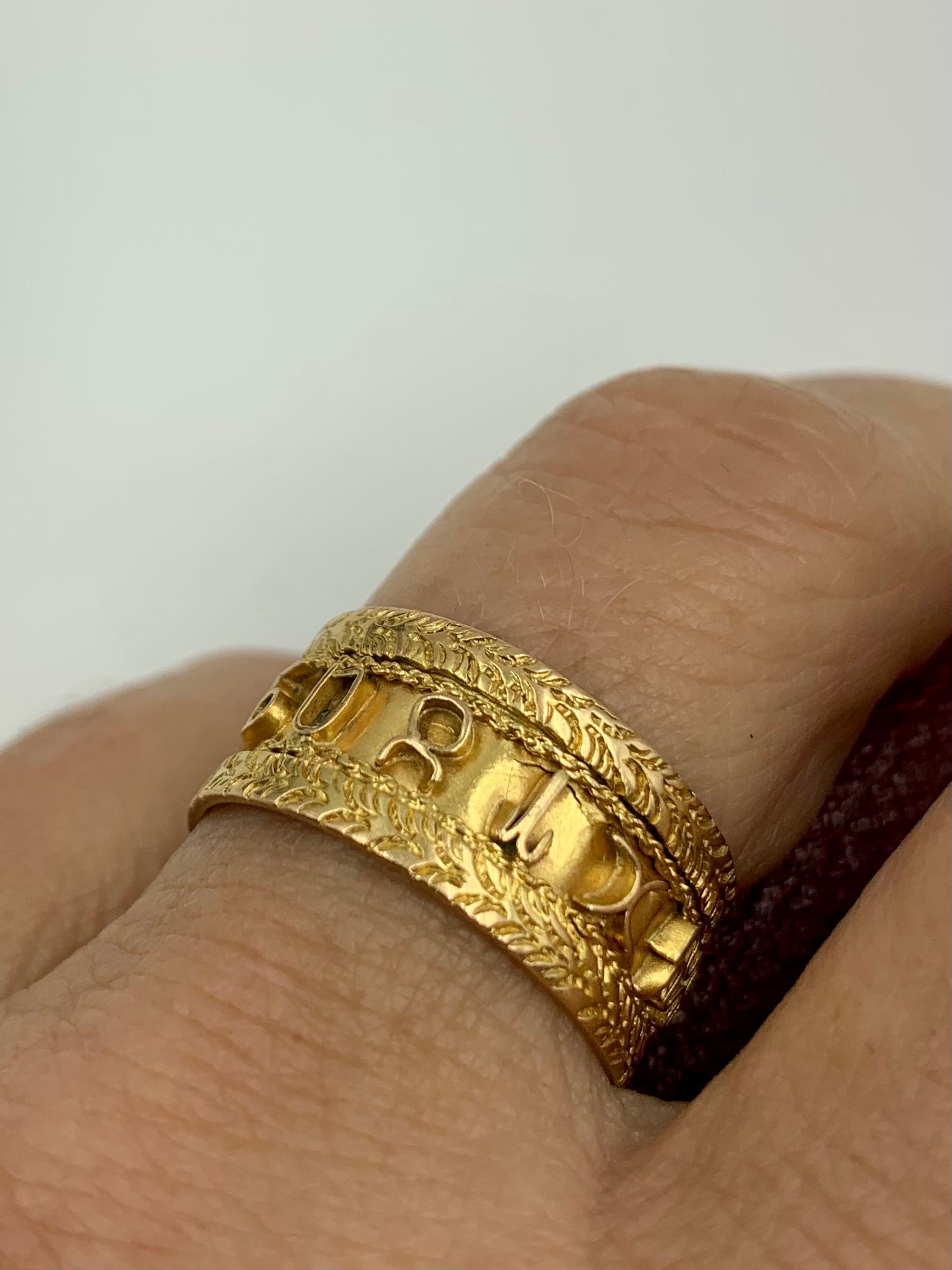 Striking wide 14K yellow gold band ring with the signs of the Zodiac symbols around the perimeter framed by attractive foliate borders. Astrological jewels have a universal appeal- most are designed as a single sign of the Zodiac. This interesting