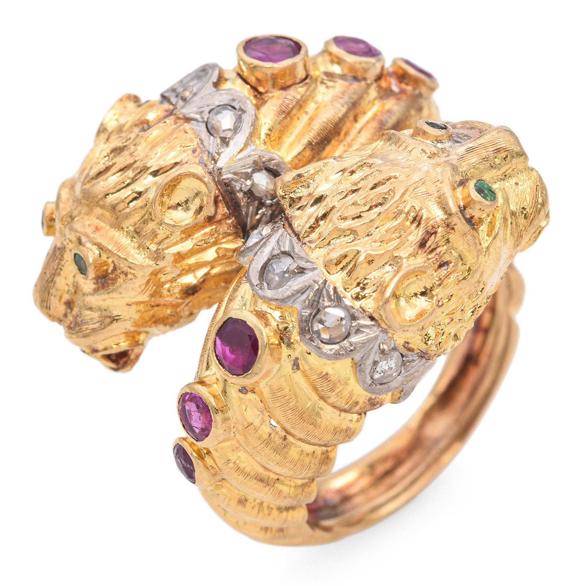 This exquisite piece is crafted in rich gold, forming the shape of two intricately detailed lion heads facing each other.
Each lion head is adorned with vibrant green emerald eyes, adding a captivating touch to the design.
The band features a series