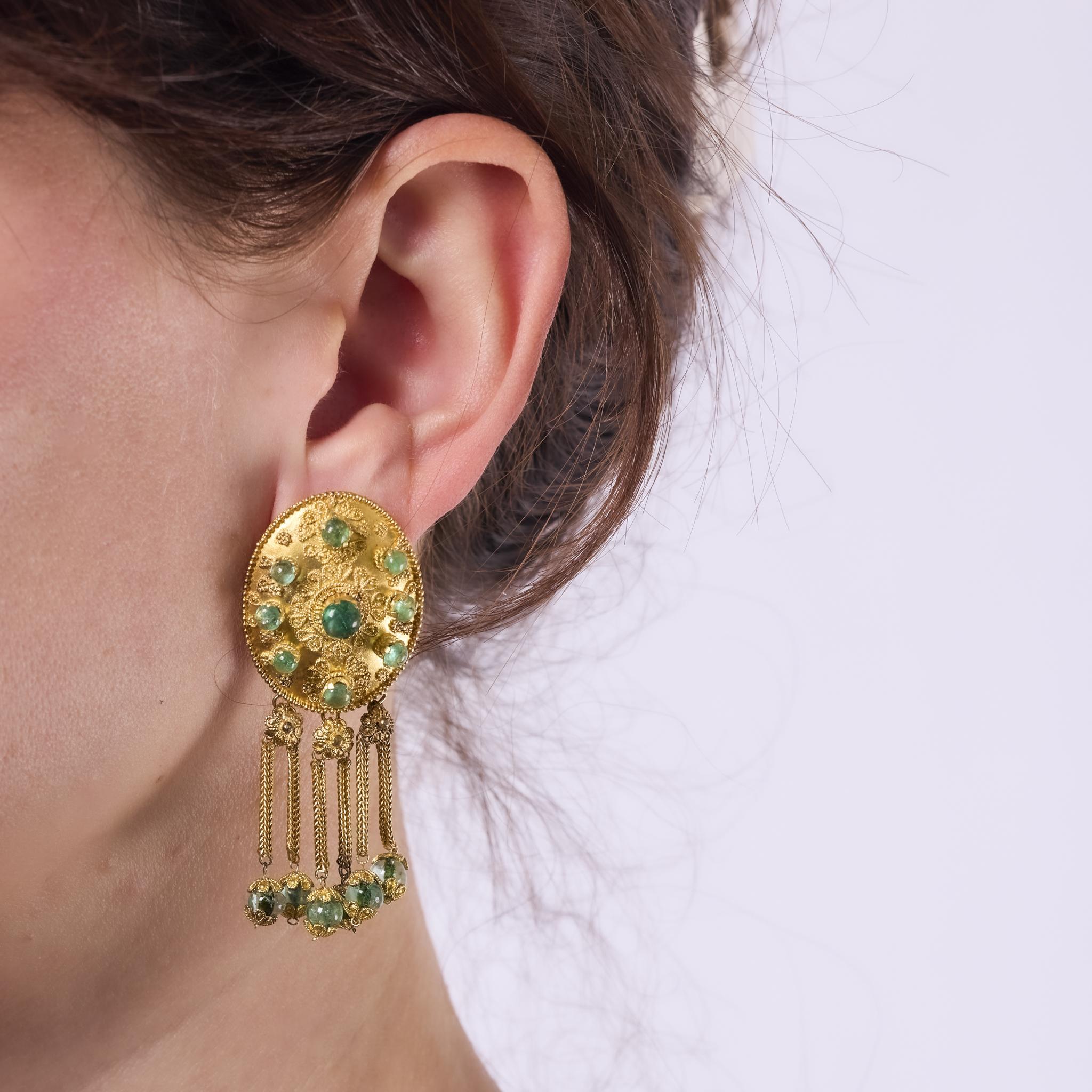 These striking vintage Zolotas earrings showcase 30 lush cabochon emeralds totaling 6.00 carats. Crafted in rich 18k yellow gold with bold 1970s Greek artistry, they embody opulence and timeless design.