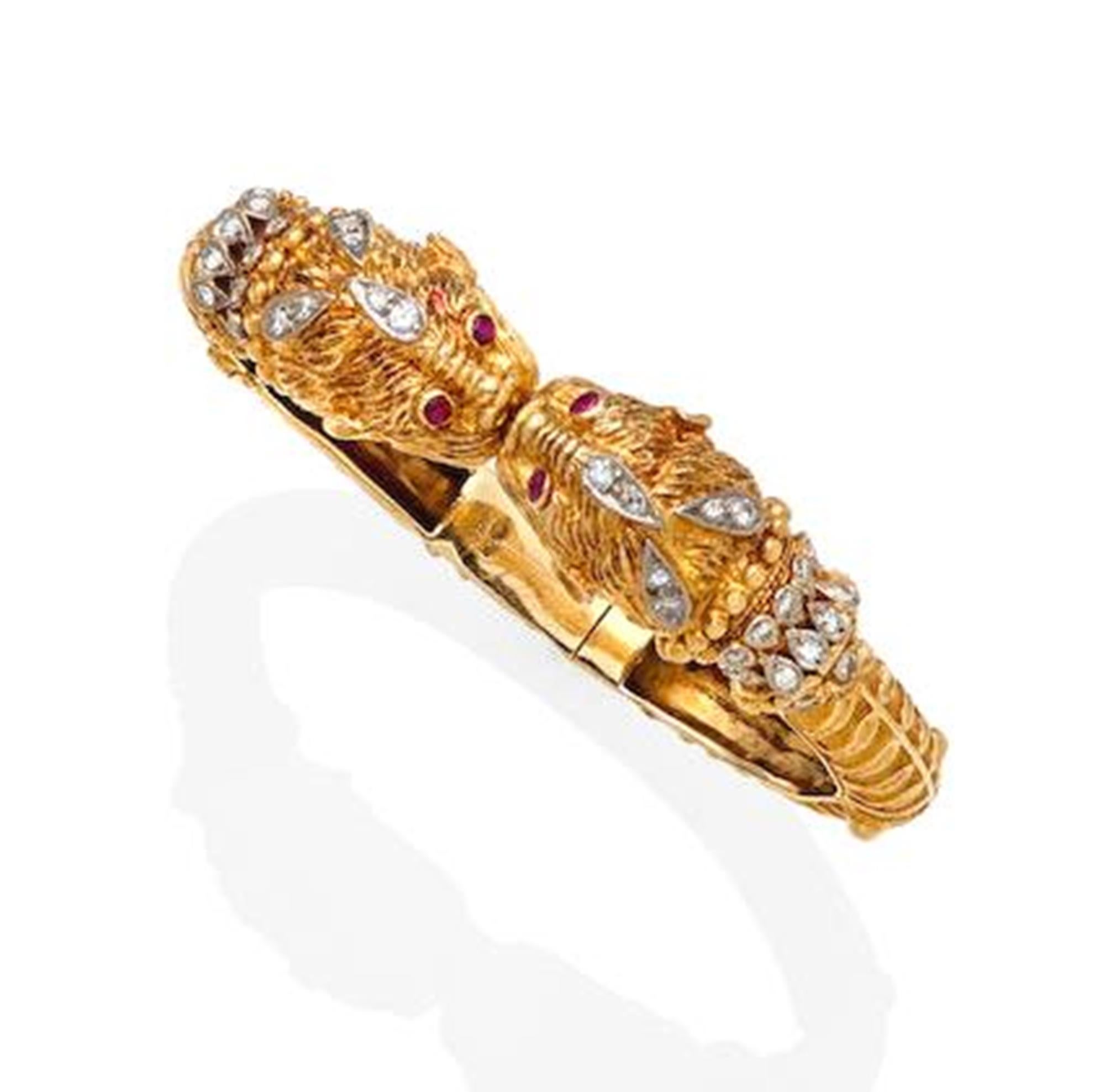 Vintage Zolotas C.1970 Ruby Diamond Double Chimera 18k Yellow Gold Bangle Bracelet. The bangle is designed with two chimera heads with ruby eyes and 46 diamonds. The 46 diamonds are H color VS-2 clarity with a total weight 1.90 carats. The bangle is