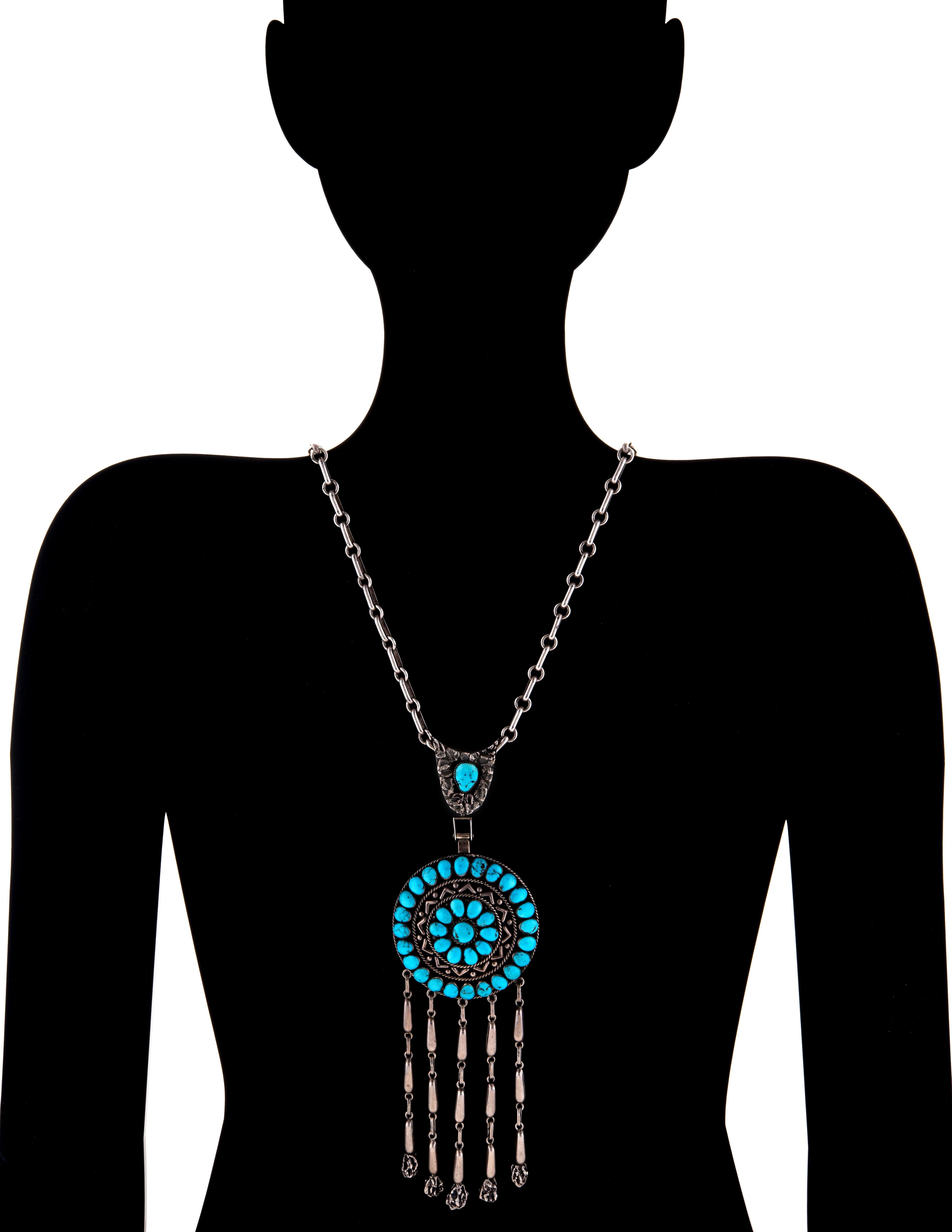 Stylish and finely detailed vintage Zuni Lee & Mary Weebothee turquoise fringe necklace crafted in sterling silver.  

Natural turquoise in various sizes is set into both sides of the pendant. The turquoise is in excellent condition and free of