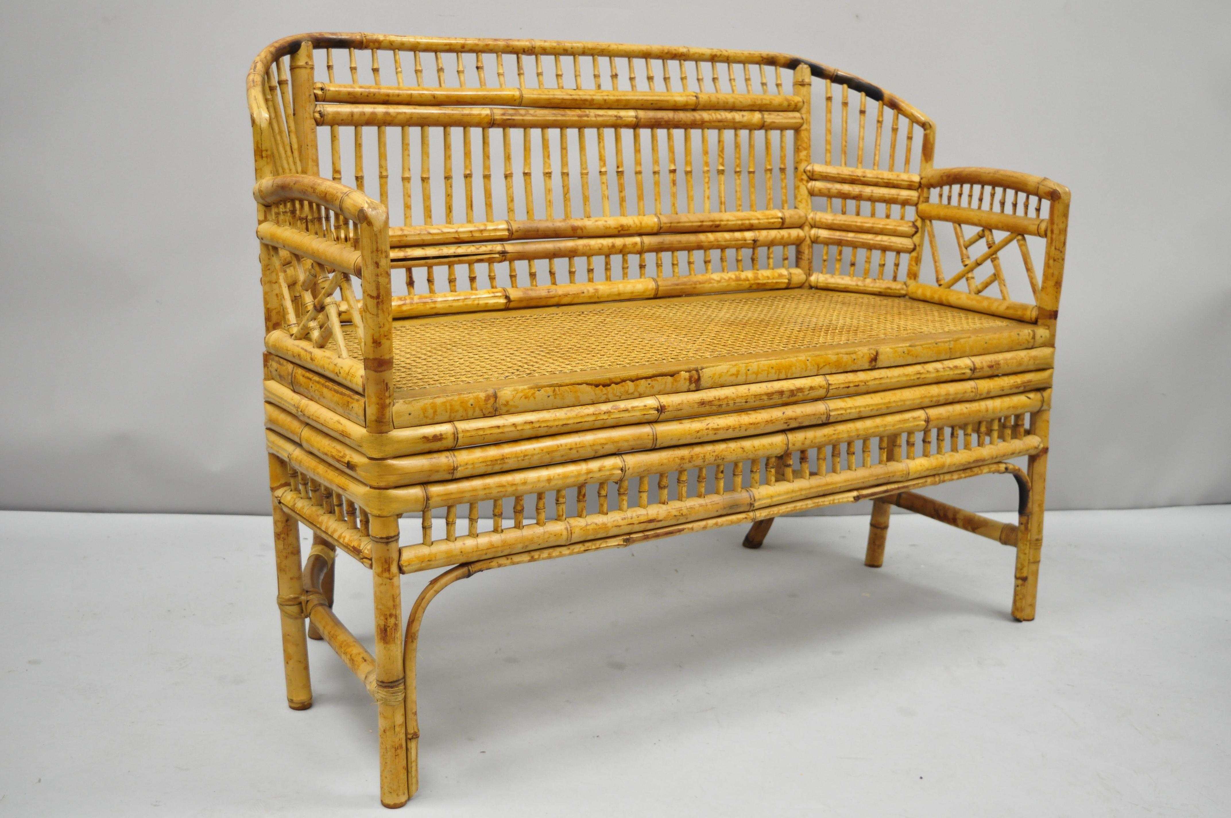 Vintage Brighton Pavilion style bamboo rattan settee Chinese Chippendale. Item features scorched bamboo frame, cane seat, quality craftsmanship, great style and form, circa mid-late 20th century. Measurements: 34