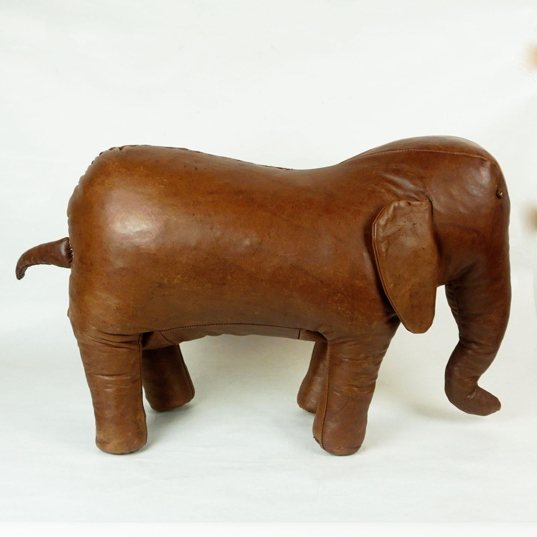 Charming Midcentury leather elephant designed by Dimitri Omersa for Abercrombie and Fitch. This piece was part of the Africa series manufactured in the 1960s. Features handstitched aged leather with tail, ears, tusks and metal eyes. Originally