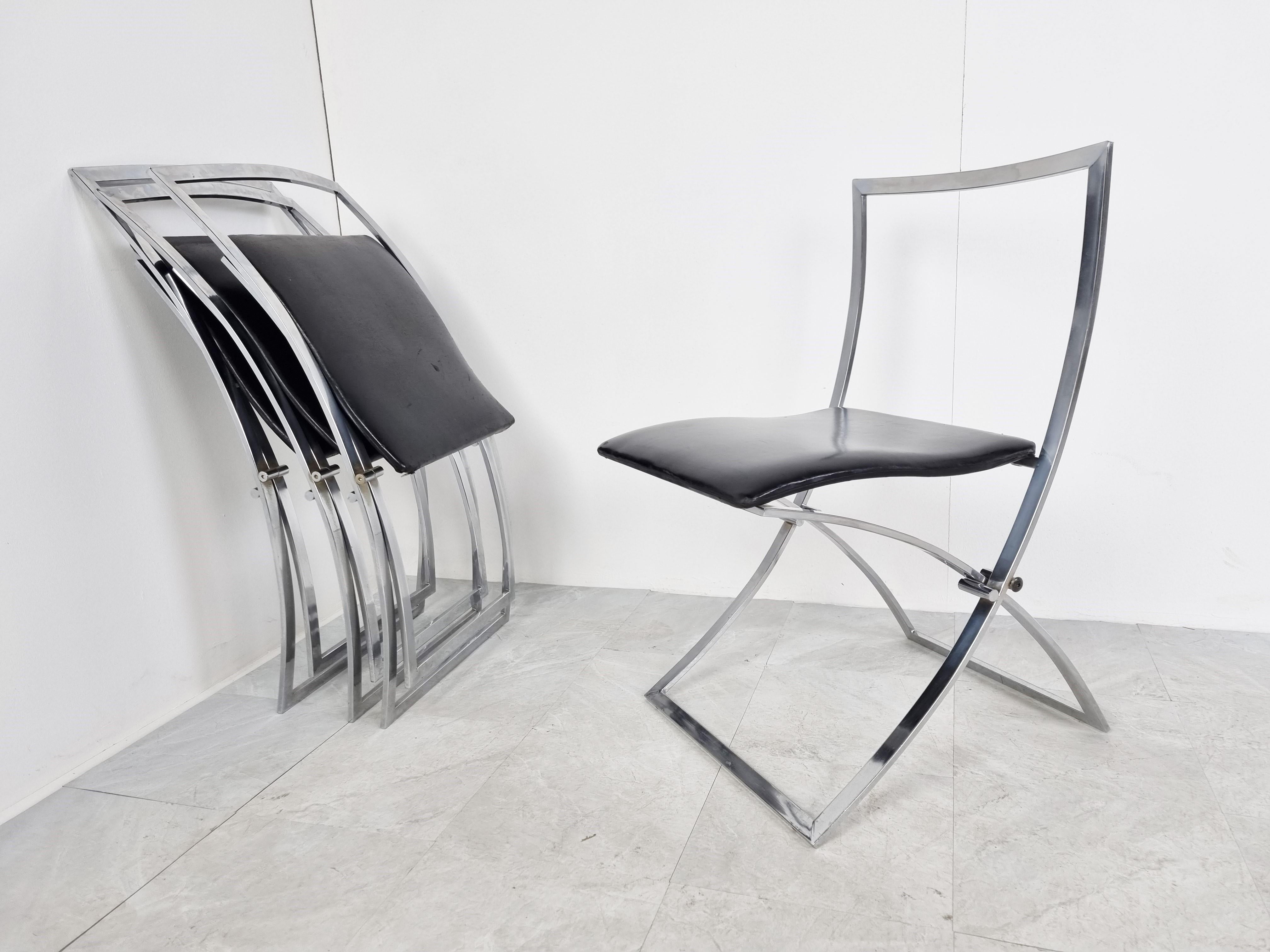 Italian chromed foldable dining chairs designed by Marcello Cuneo for Mobel. Model Luisa

These elegant chairs have a timeless design and are upholstered with their original black leather seats.

Good original condition with normal age related
