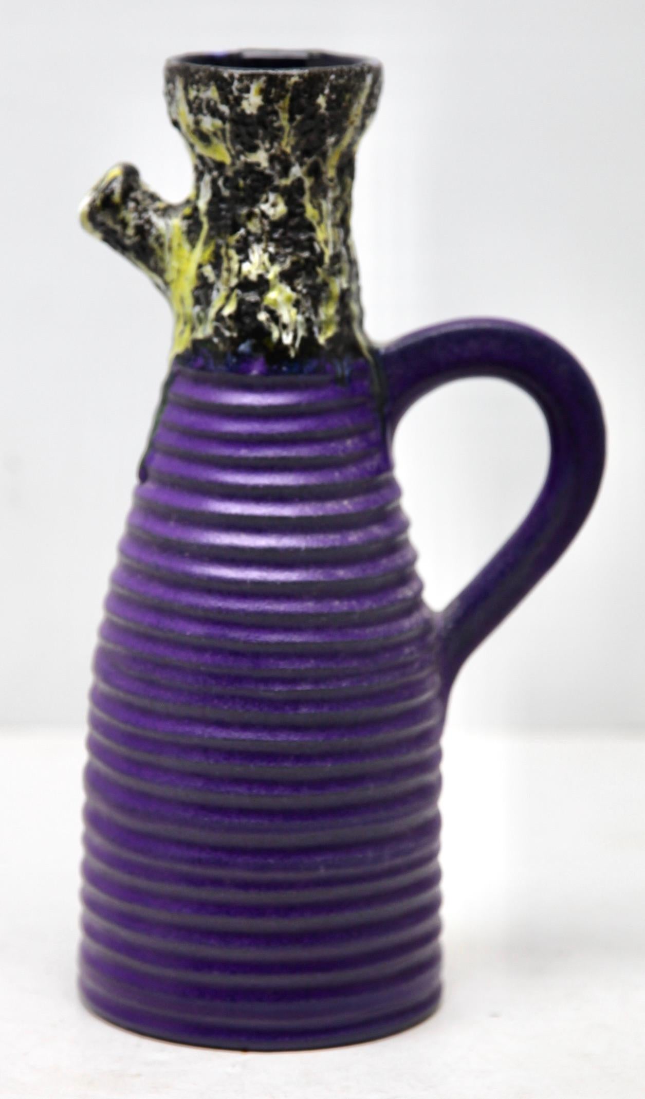 A classic 60s design. Of fat lava handled vase, pitcher in the classic sixties decor; with a rough glaze of dark earth-colour over the yellow and black. 
W-Germany. 
Hand decorated glaze.
Stunning color.

