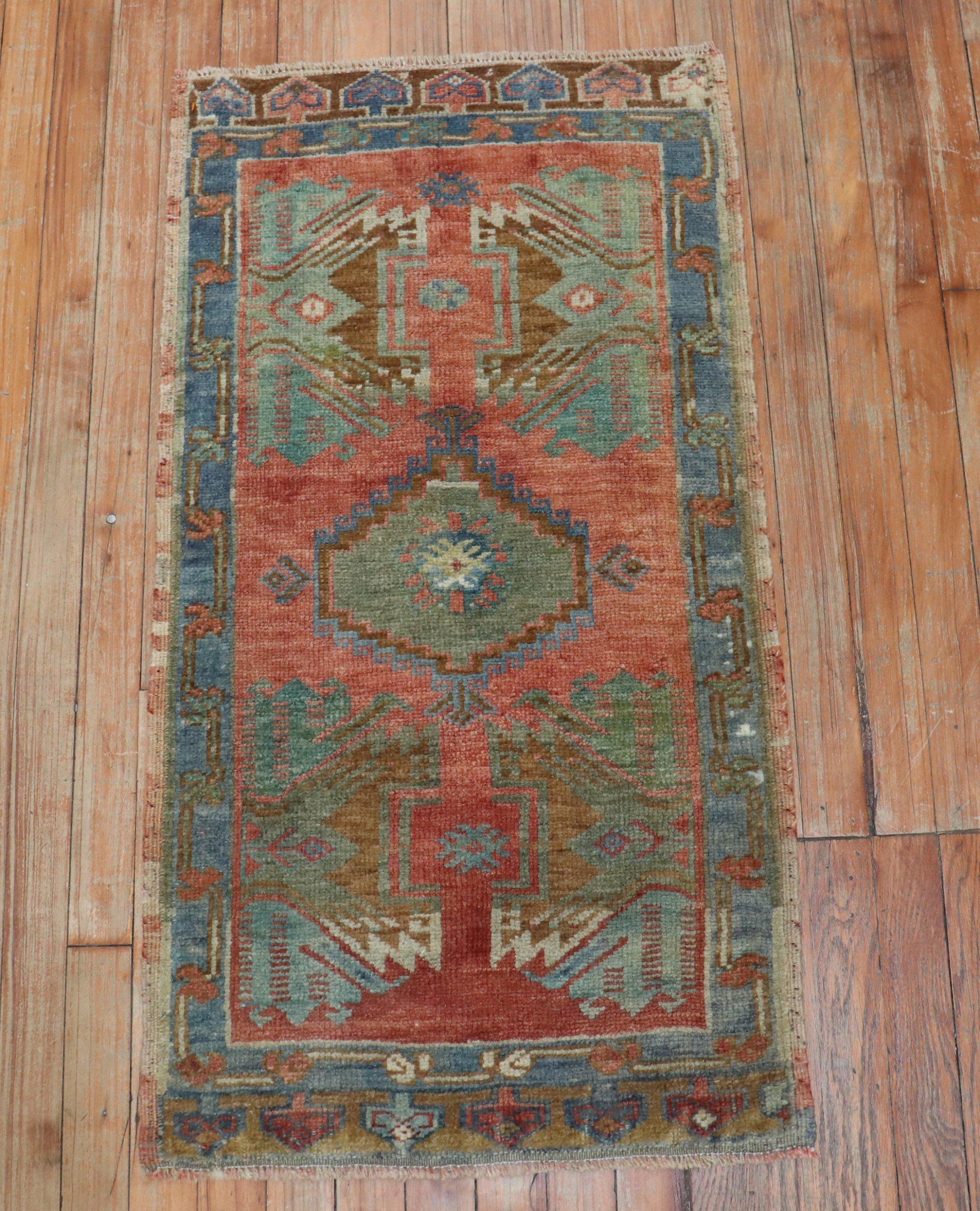 Vintage Turkish Yastik Rug with green and gray accents on a brick color field

Measures: 22” x 42”.