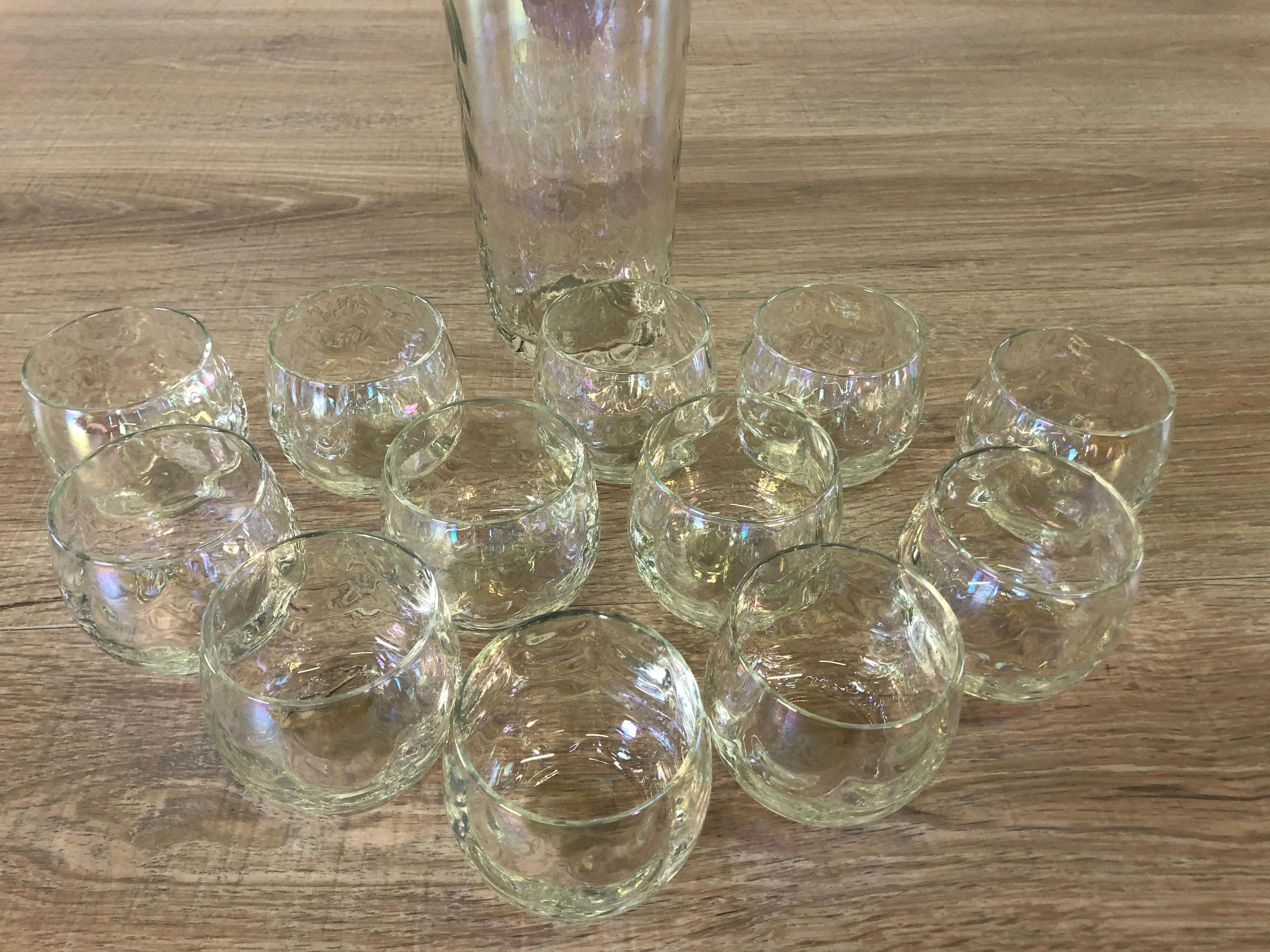 Vintage 1960s set of 13 iridescent cocktail shaker and 12 roly poly style tumblers. The tumblers measure 2.5” diameter 2.5” height. The shaker has a chrime lid in excellent condition. No marks.