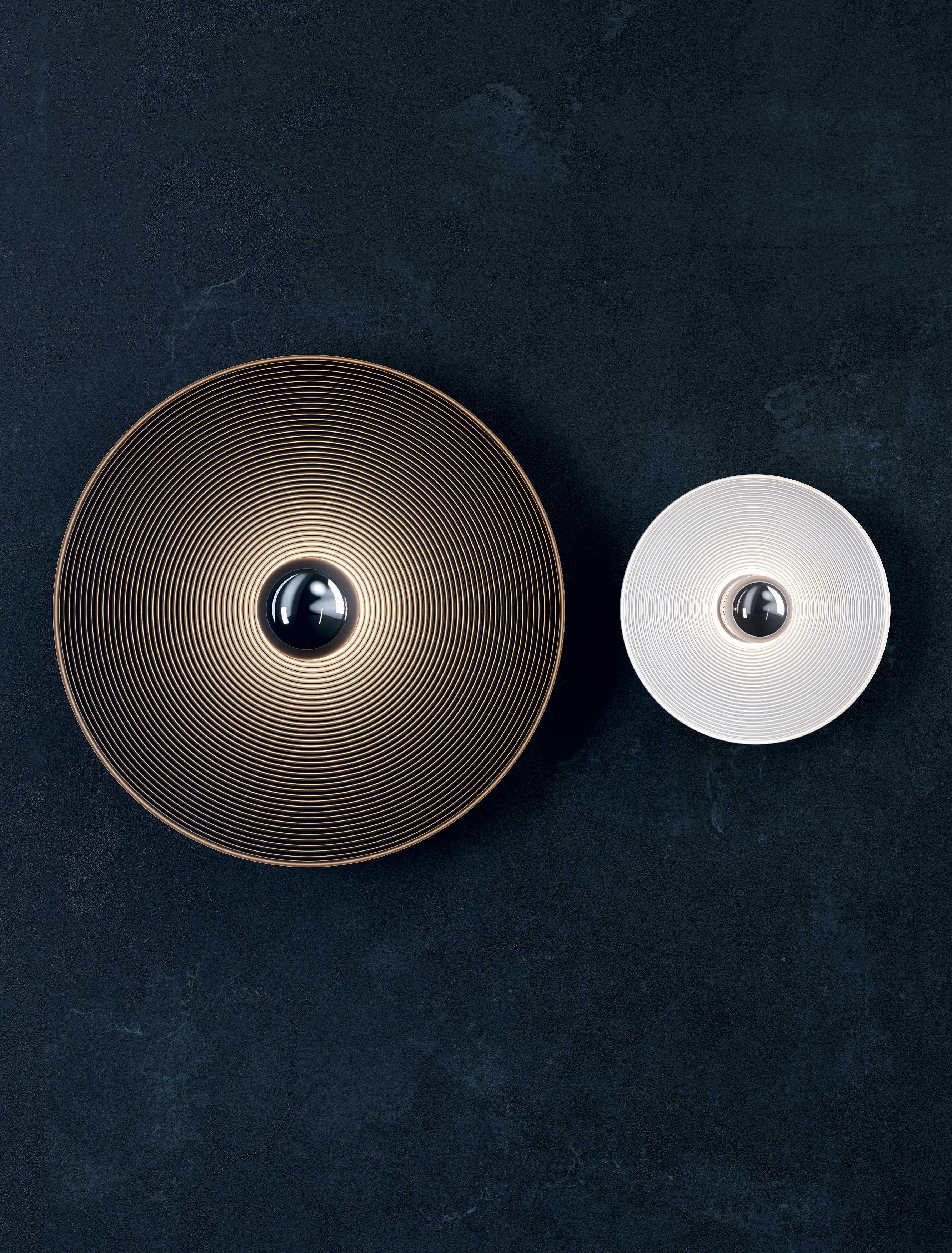 An extremely graphic lamp, Vinyl is made up of a metal plate with a circular engraved texture reminiscent of a music record, emulating sound vibrations whilst dividing the light in a captivating manner to the human eye.

Vinyl is a versatile, spun