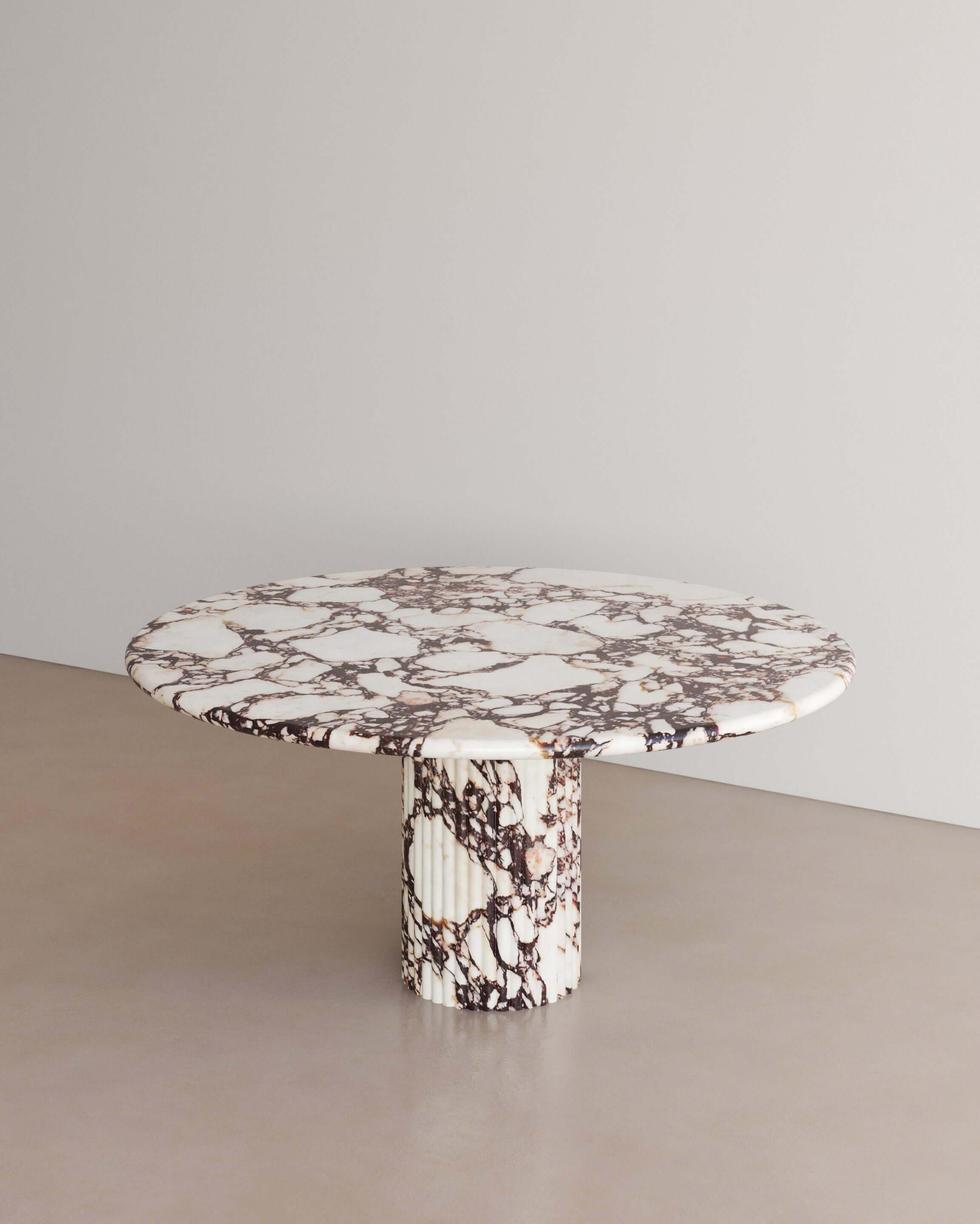 The Essentialist brings you The Antica dining table I in Calacatta Viola Marble . An oval table top resolved by smooth bullnose edges rests on two supporting pillars. Architectural form is refined by artistic expression echoing Roman culture. This