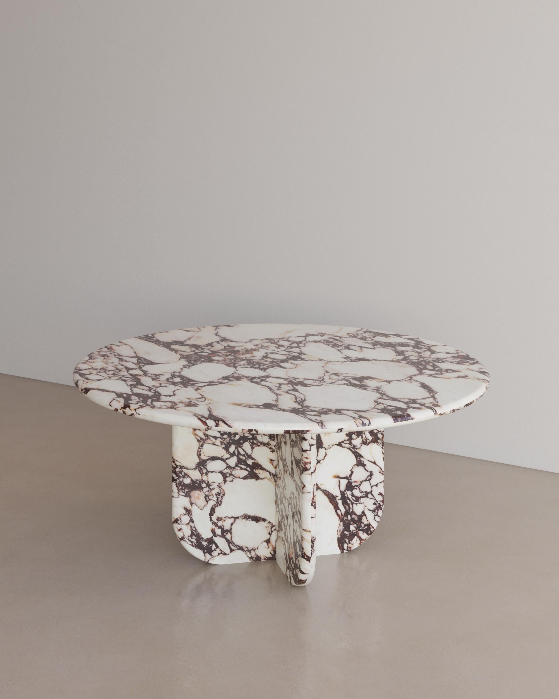 The Essentialist presents the Ètoile Dining Table I in Calacatta Viola Marble. A bold rounded circle effortlessly stacks upon a four point star. Smooth planes exonerate beautiful natural patterning, forging a statement of minimalism that embodies