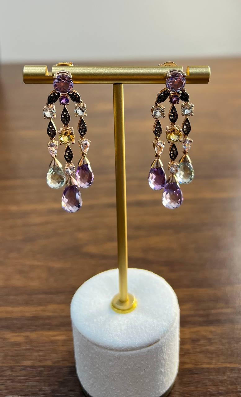 Enhance your elegance with these stunning drop earrings crafted in 14k rose gold.

The rich purple of the amethysts is beautifully complemented by the warm yellow of the citrines. Accents of blue topaz and green prasiolite add a touch of