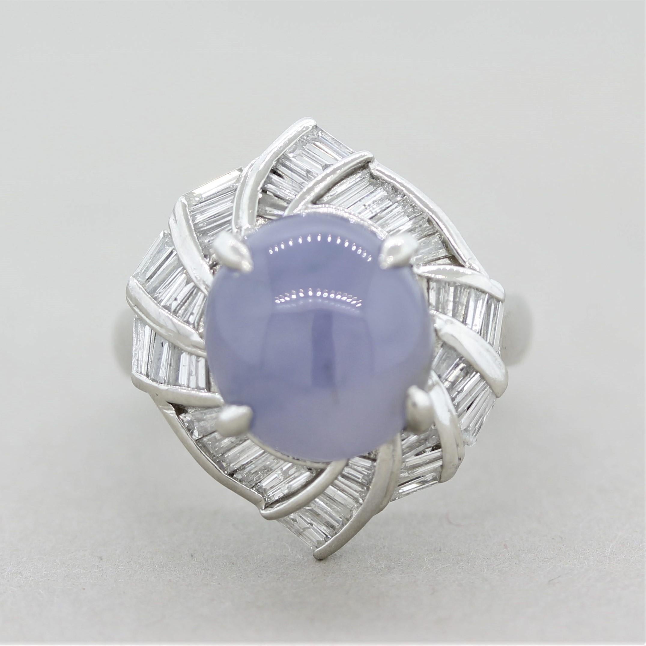 A unique and natural colored piece of jadeite jade! The violet/blue colored jade weighs 6.73 carats and has a smooth sleek polish. It is accented by 1.20 carats of baguette-cut diamonds which are set in a swirling pattern around the jade.
