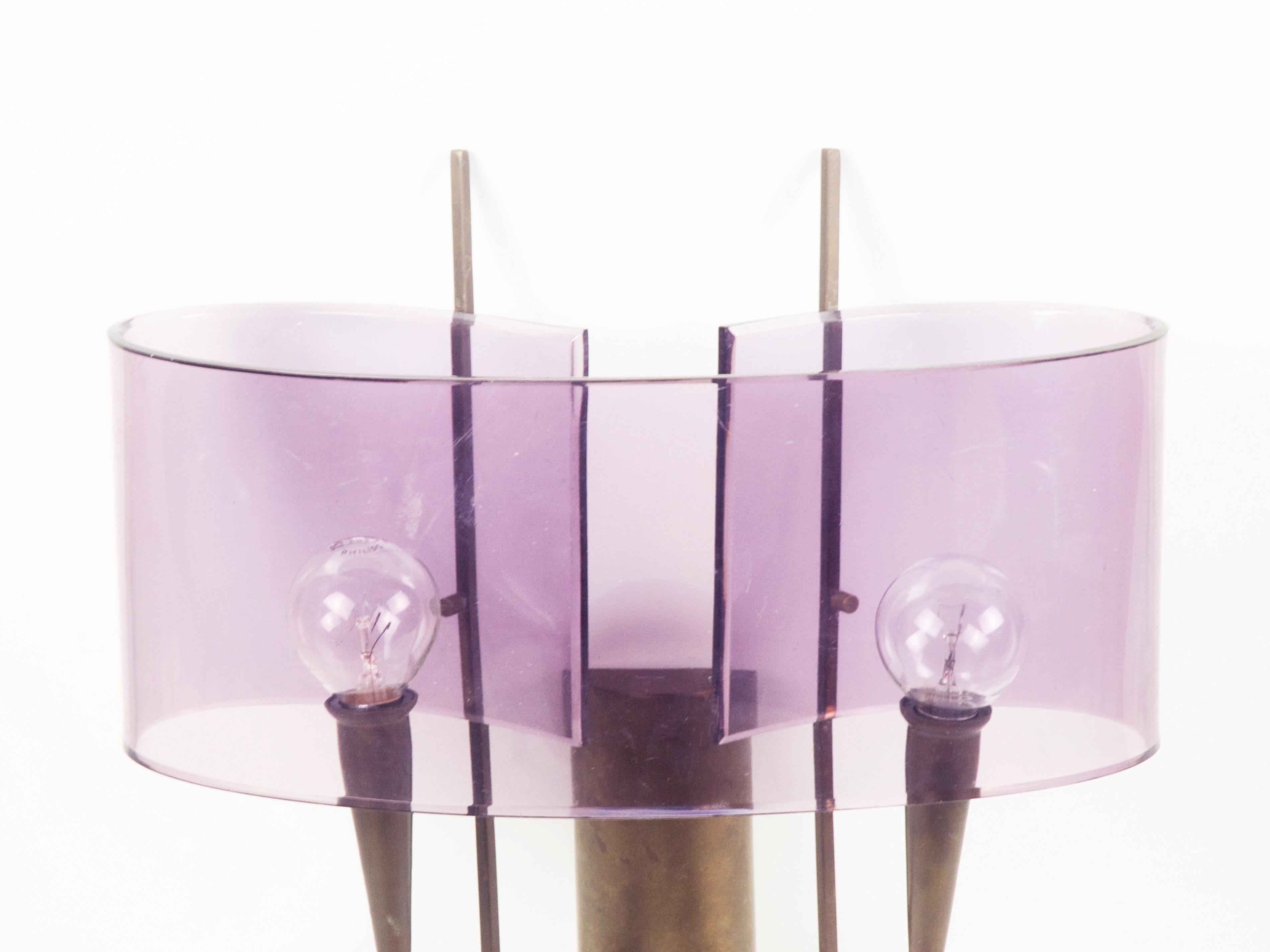 Pair of wall sconces made from brass and violet perspex shade. Very good condition: signs of oxidation of the brass structure and very slight signs of wear of the plastic lampshades.
