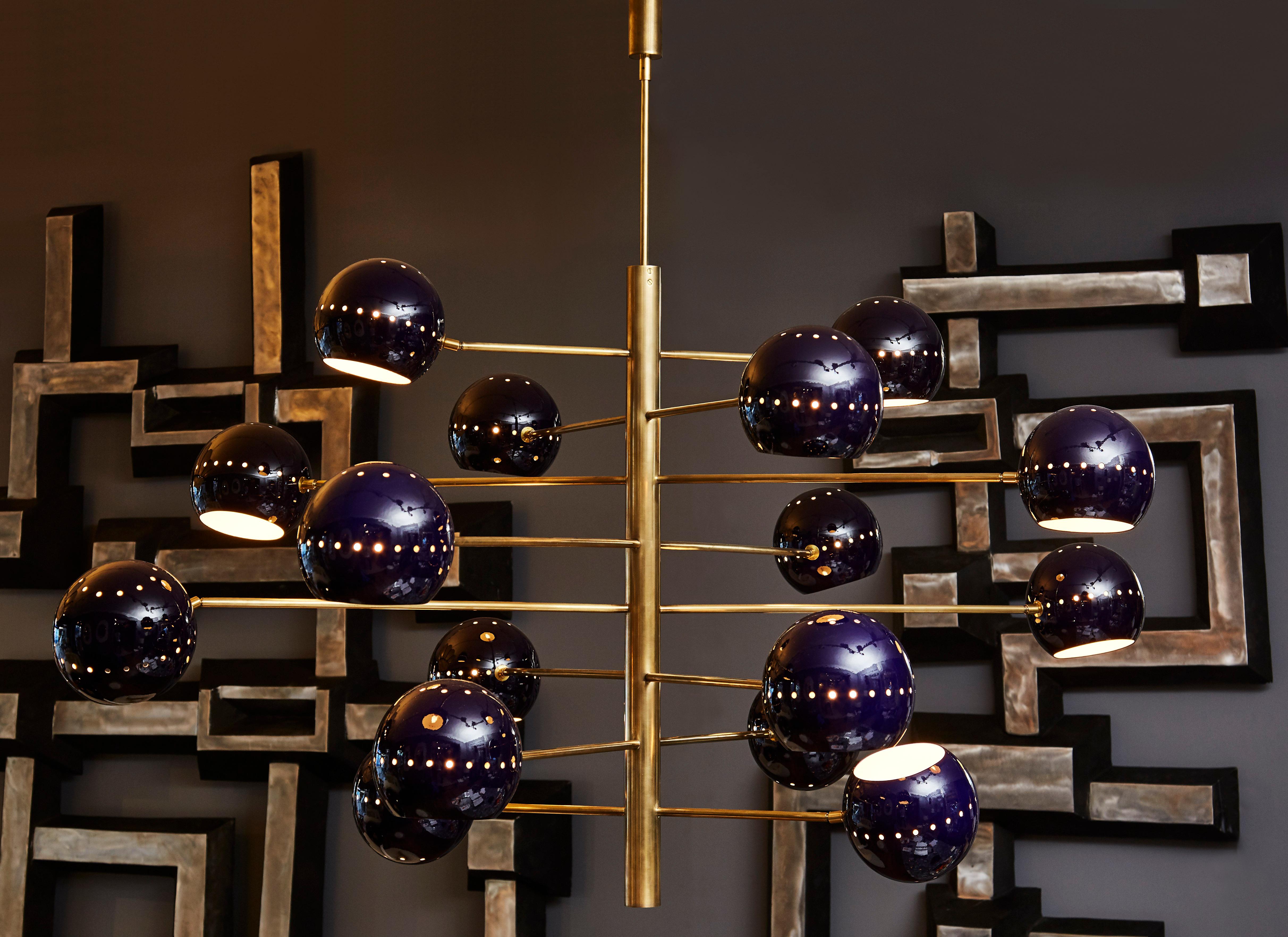 Exceptional brass chandelier with 16 arms and violine tainted steel globes. 16 light bulbs. Unique and signed piece by Diego M. for the Studio Glustin.
Made on order in Italy.      