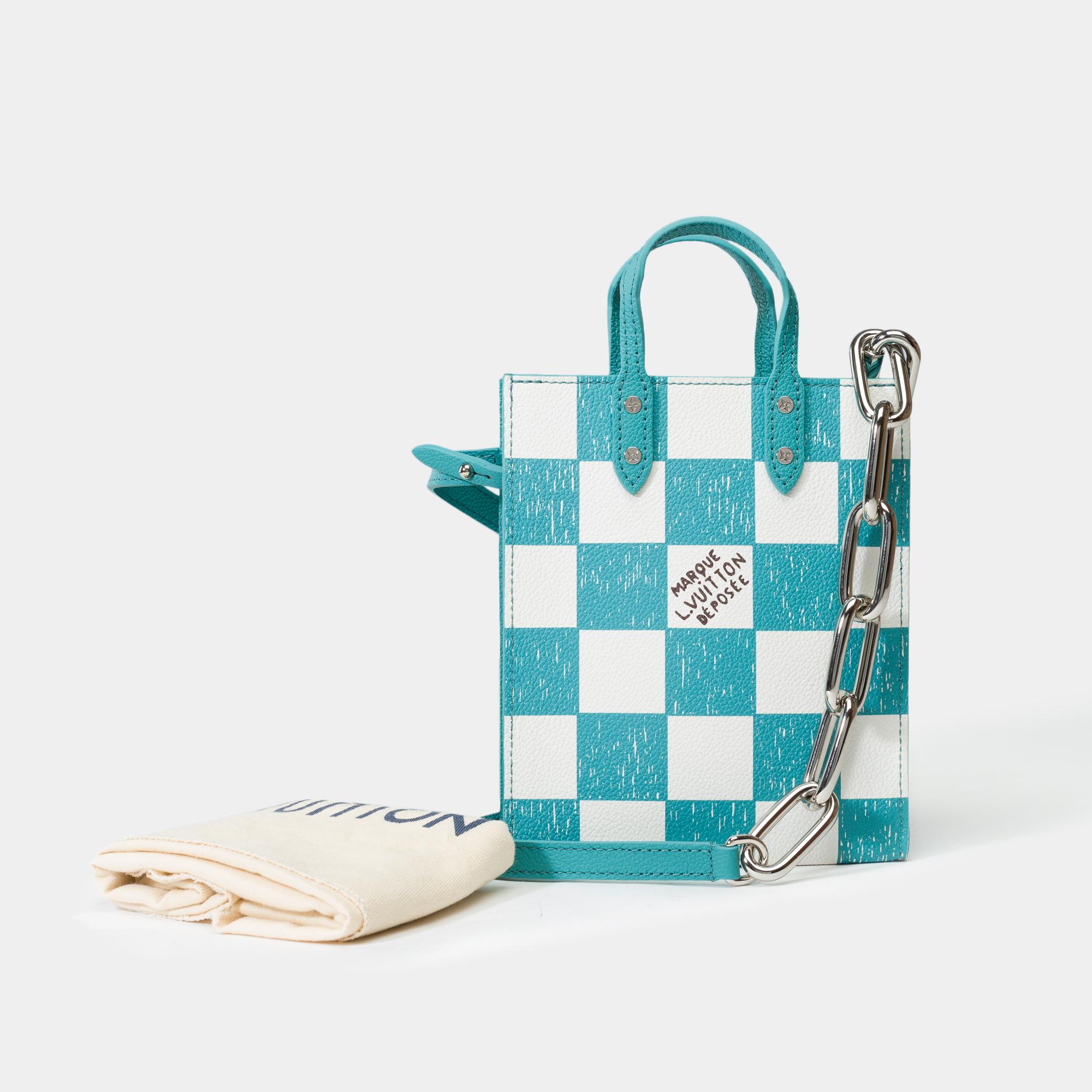Louis​ ​Vuitton​ ​Plat​ ​XS​ ​Bag​ ​Limited​ ​Edition​ ​Virgil​ ​Abloh​ ​Collection​ ​in​ ​checkerboard​ ​coated​ ​canvas​ ​and​ ​white​ ​checkered​ ​pattern,​ ​featuring​ ​blue​ ​leather​ ​handles​ ​for​ ​hand​ ​carry

Interior:​ ​blue​