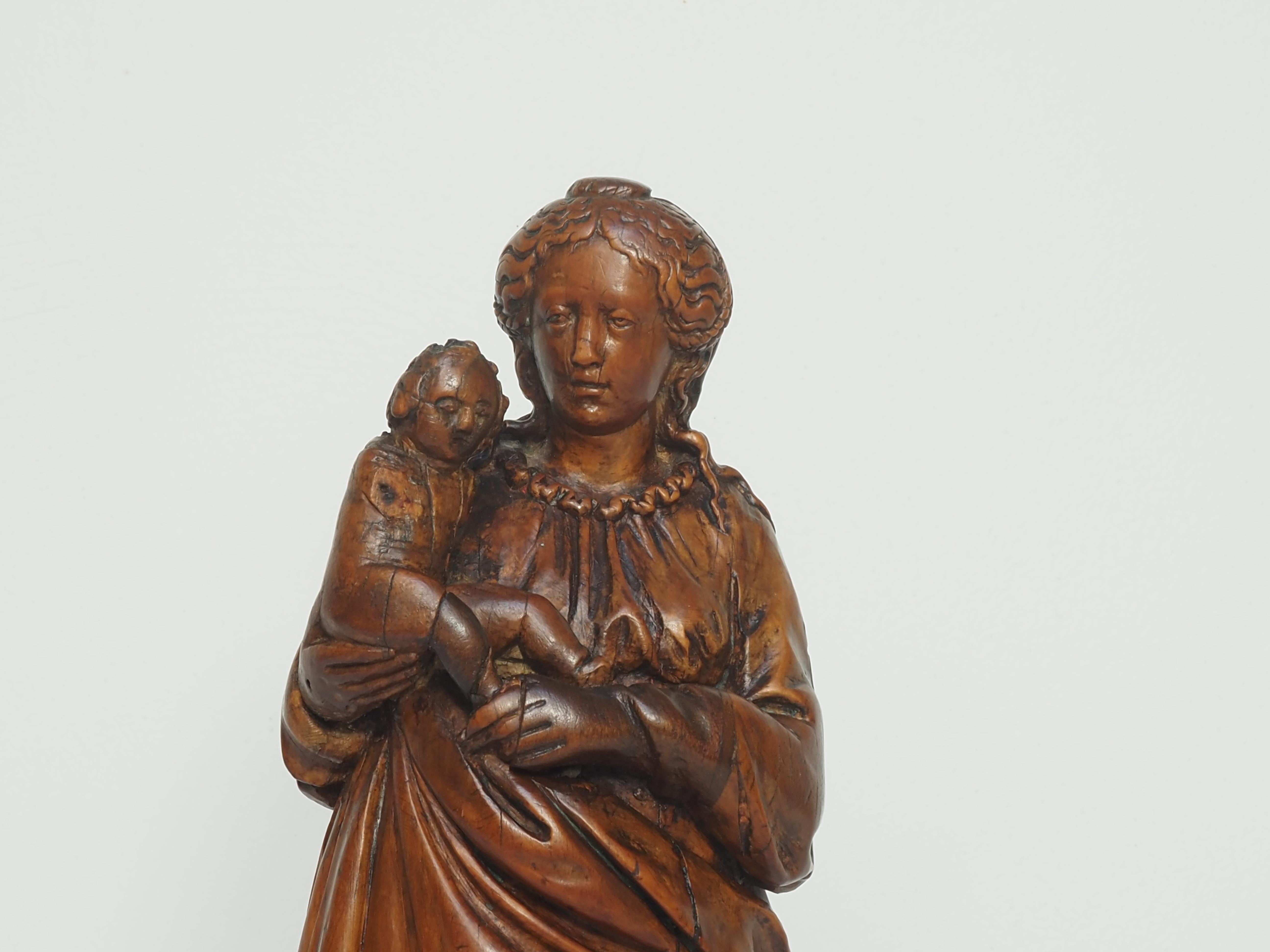 Probably pearwood, Flanders, first quarter of the 17th century

This intimate representation of the Virgin and Child is carved in warmly toned wood. Mary, standing, carries the Child on her right arm, close to her body, while her left hand supports