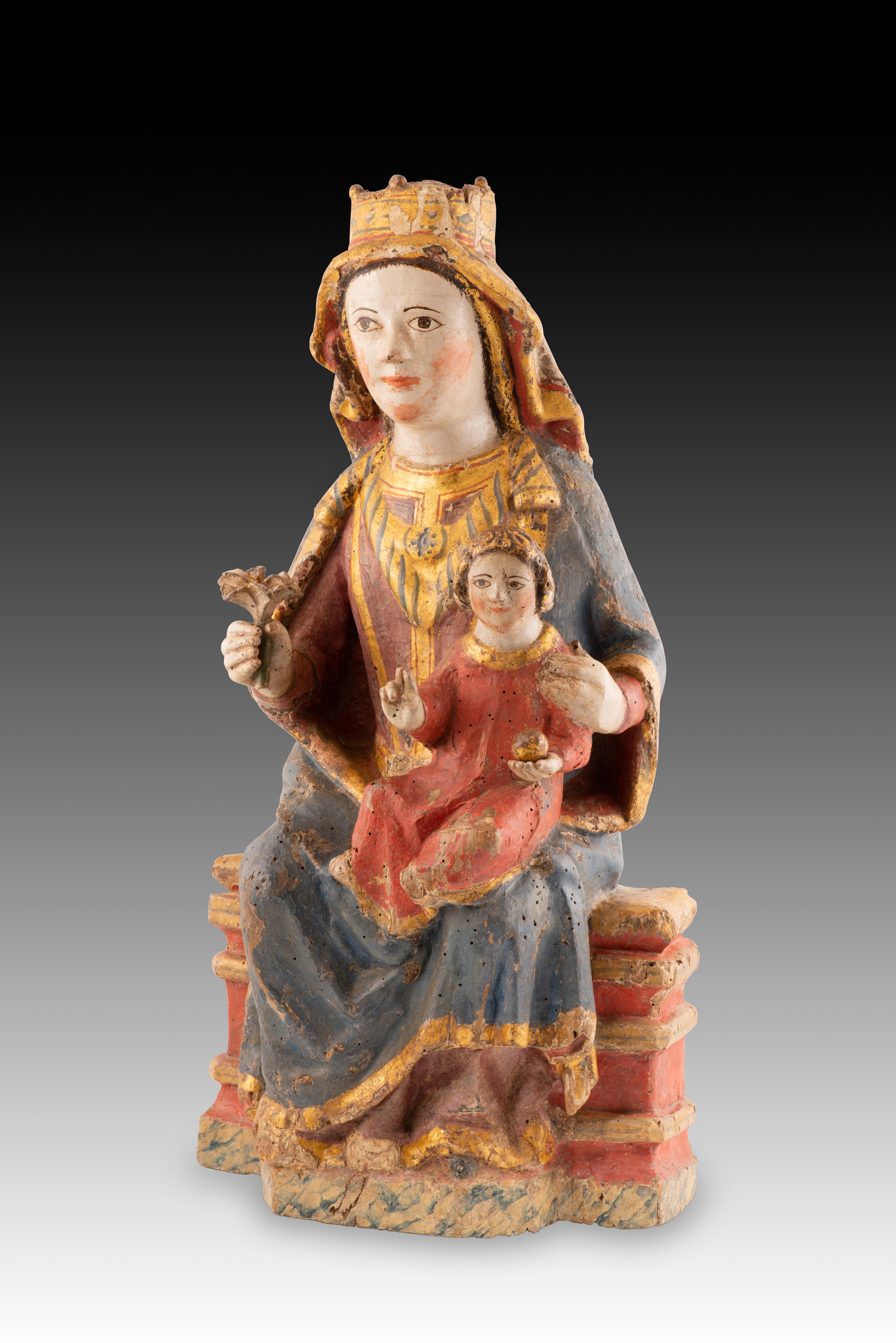 Virgin and Child Jesus. Carved and polychrome wood. Spanish School, 14th century. 
A polychrome wooden carving with gold highlights depicting the Virgin Mary seated on a low throne, wearing a cloak, tunic, crown, headdress, and jewels, holding an