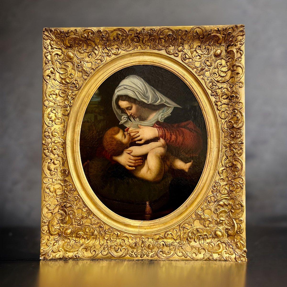 Very fine 19th century oil painting of the Virgin and Child, oil on canvas, in a massive carved and gilded wooden frame. 
The painting is of the French school, probably inspired by a similar painting by a better-known artist.

