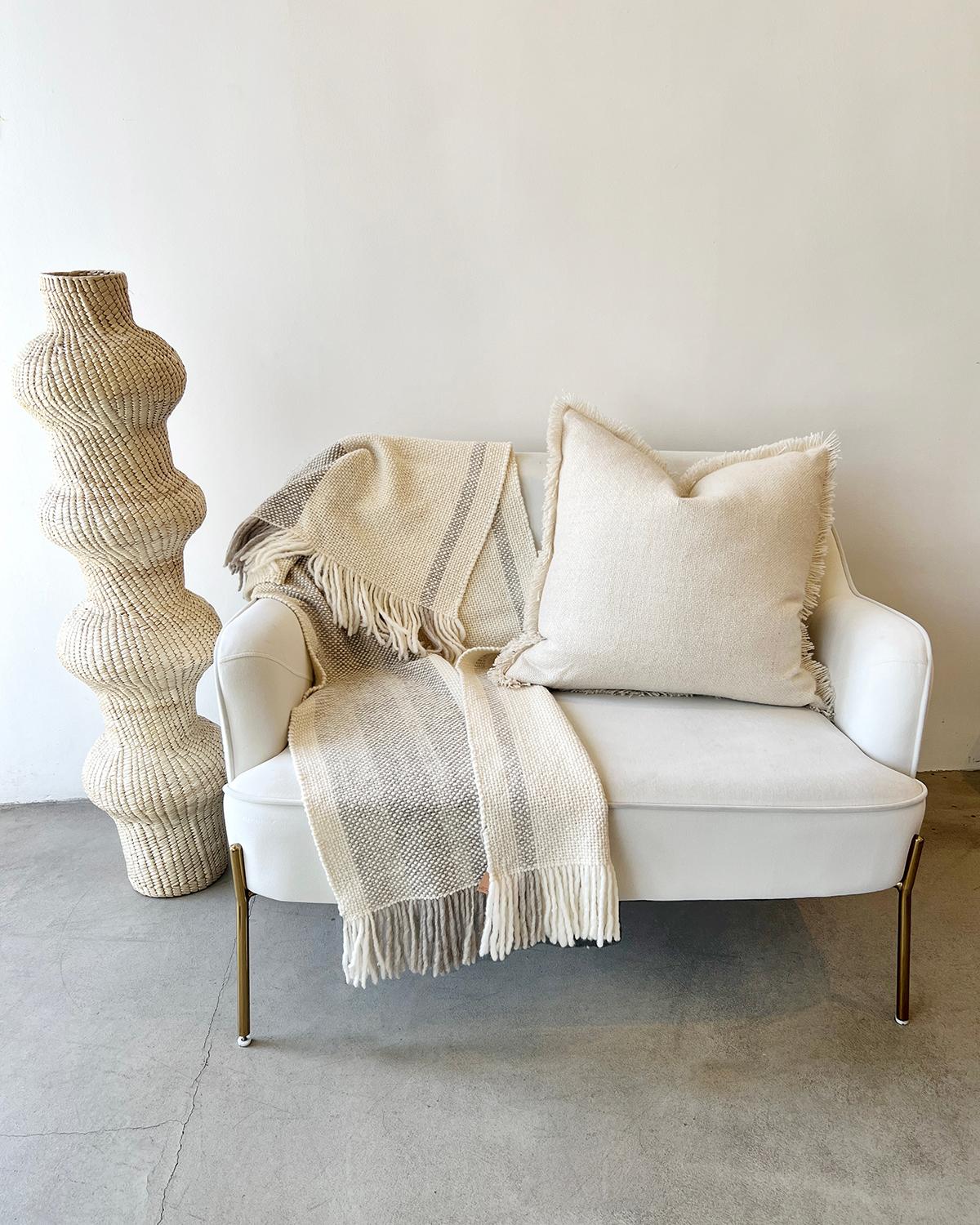 This lovely cream open weave handwoven throw pillow is made from hand spun virgin llama wool, woven by hand by master weavers who live in the remote area of La Puna, Argentina, using ancestral techniques. The entire process from shearing to final