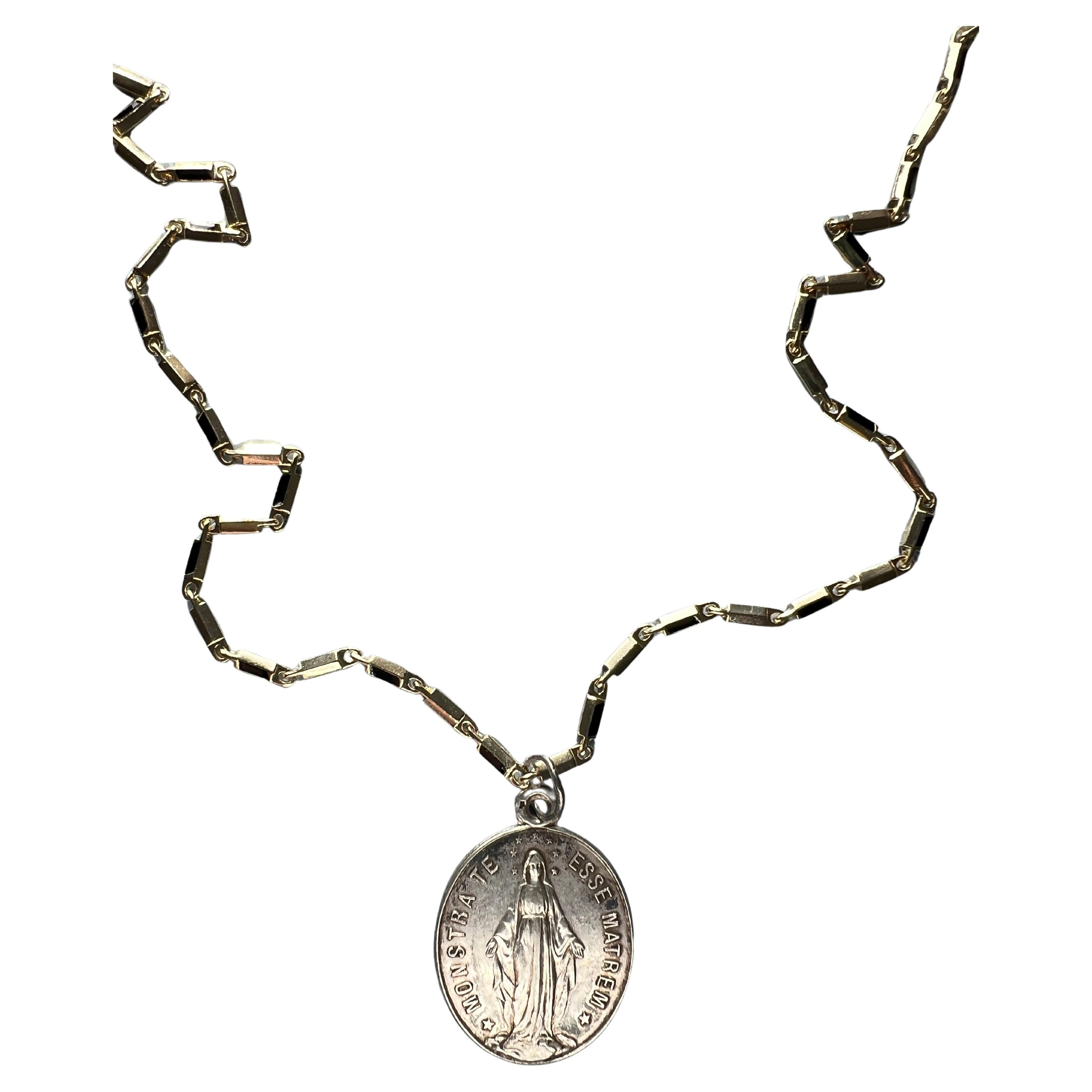 Virgin Mary Medal Chain Necklace

Vintage French Silver Medal combined with a modern 14k Gold plated Chain that has white enamel.

Symbols or medals can become a powerful tool in our arsenal for the spiritual. 
Since ancient times spiritual