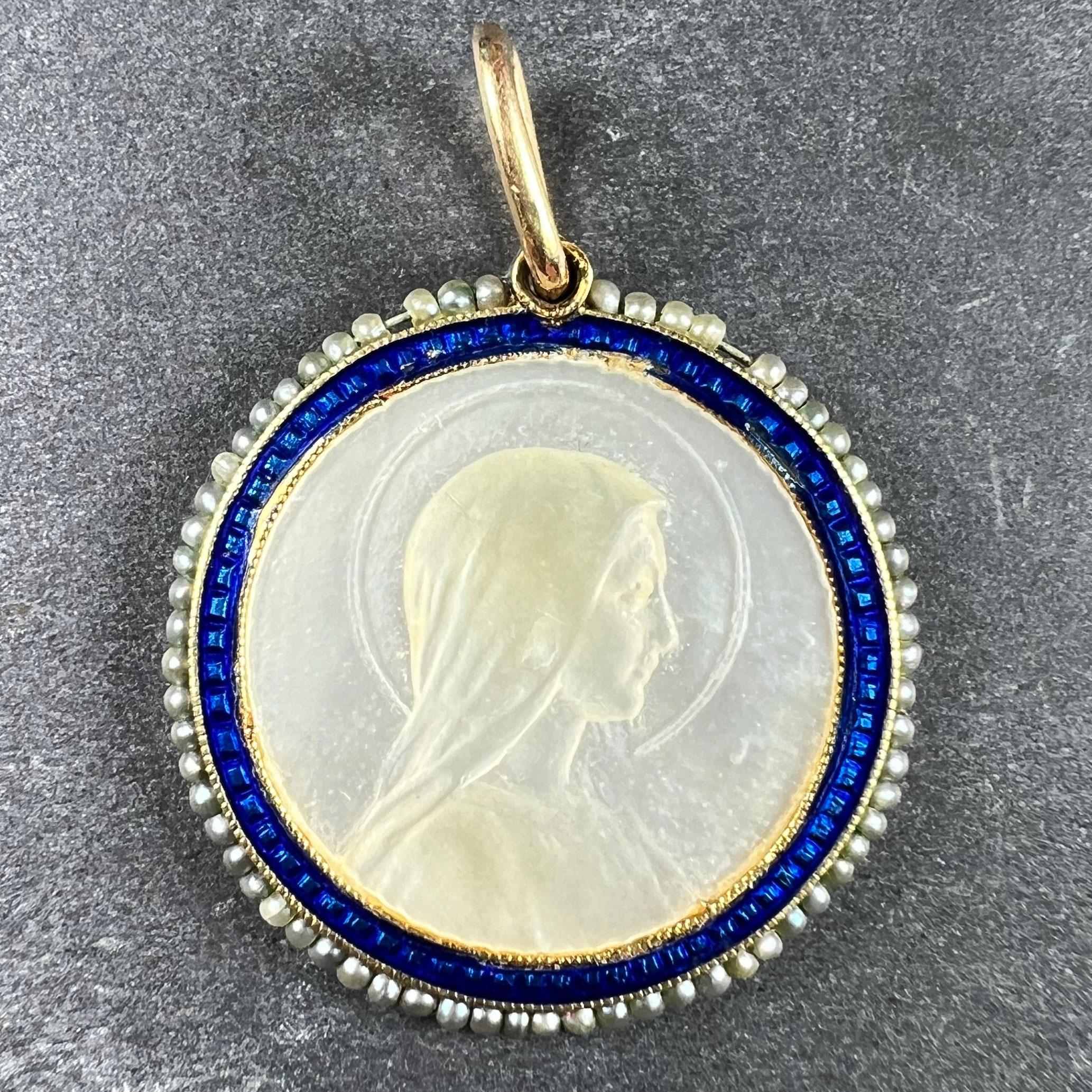 An 18 karat (18K) yellow gold charm pendant designed as a mother-of-pearl medal depicting the Virgin Mary within a blue enamel frame surrounded by 64 natural seed pearls. Umarked but tested for 18 karat gold.

Dimensions: 2.1 x 2 x 0.17 cm (not