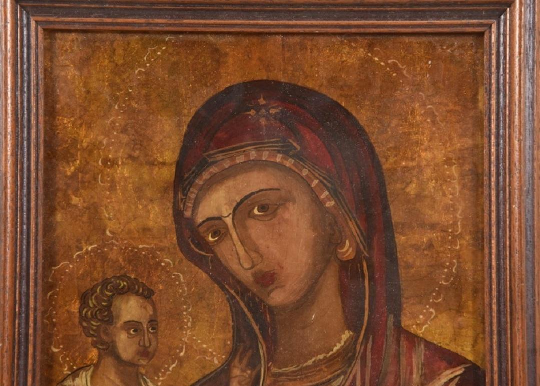 This beautiful icon of Virgin Mother Mary with Christ Child is a reverse painting on glass, mixed media with gold leaf and oil paints, with original wooden frame, Bulgaria, 1940-1949. 
Dimensions:
With frame: H 12.75
