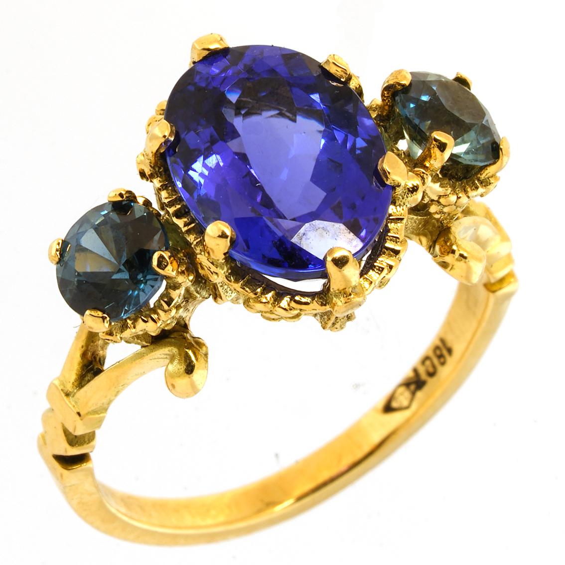 Conjuring the moody violets and steely blue hues of Leonardo’s painting ‘Virgin on the Rocks’ this exquisite ring, delicately handcrafted in 18kt yellow gold, features a breathtaking violet blue oval cut Tanzanite. Adorned with fine floral details